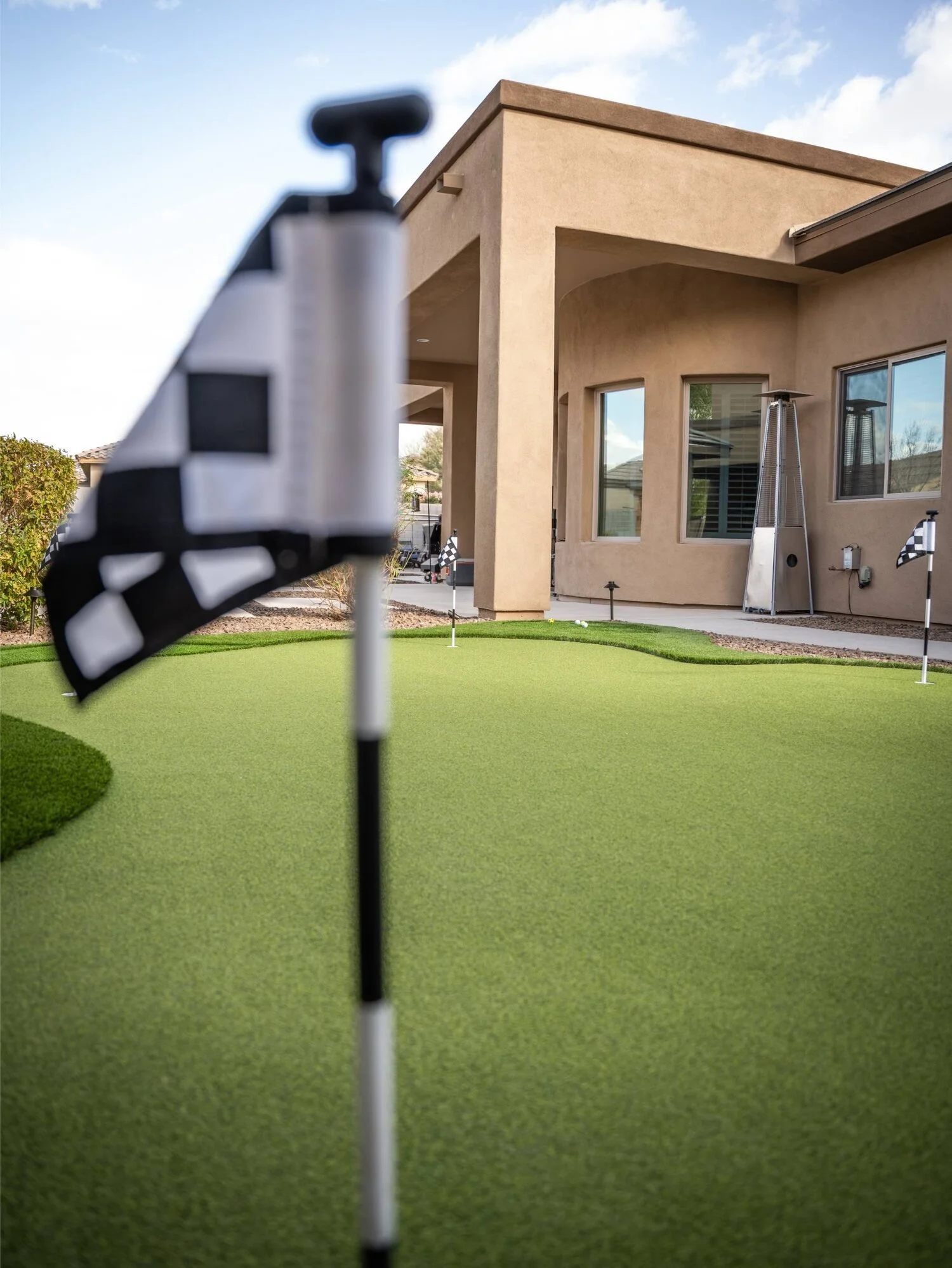 Golf flag and putting green beside patio in Scottsdale, AZ