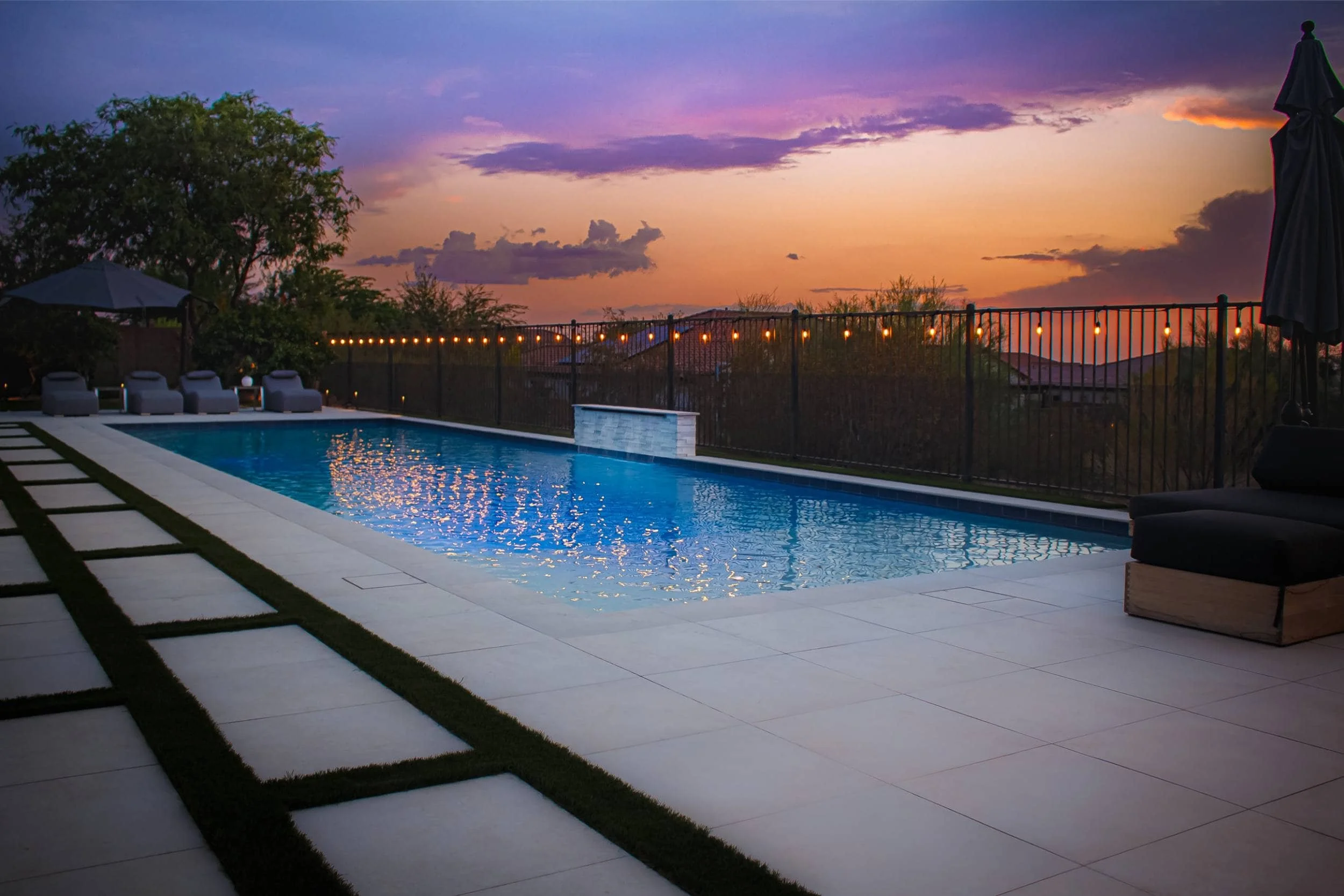 A twilight outdoor living space in Arcadia, AZ with soft outdoor lighting along the landscape design