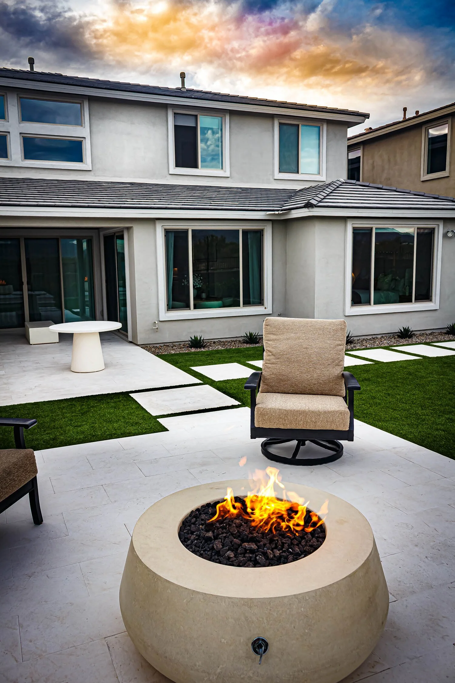 Round fire tables creating a cozy gathering spot on a turf patio in Arcadia, AZ