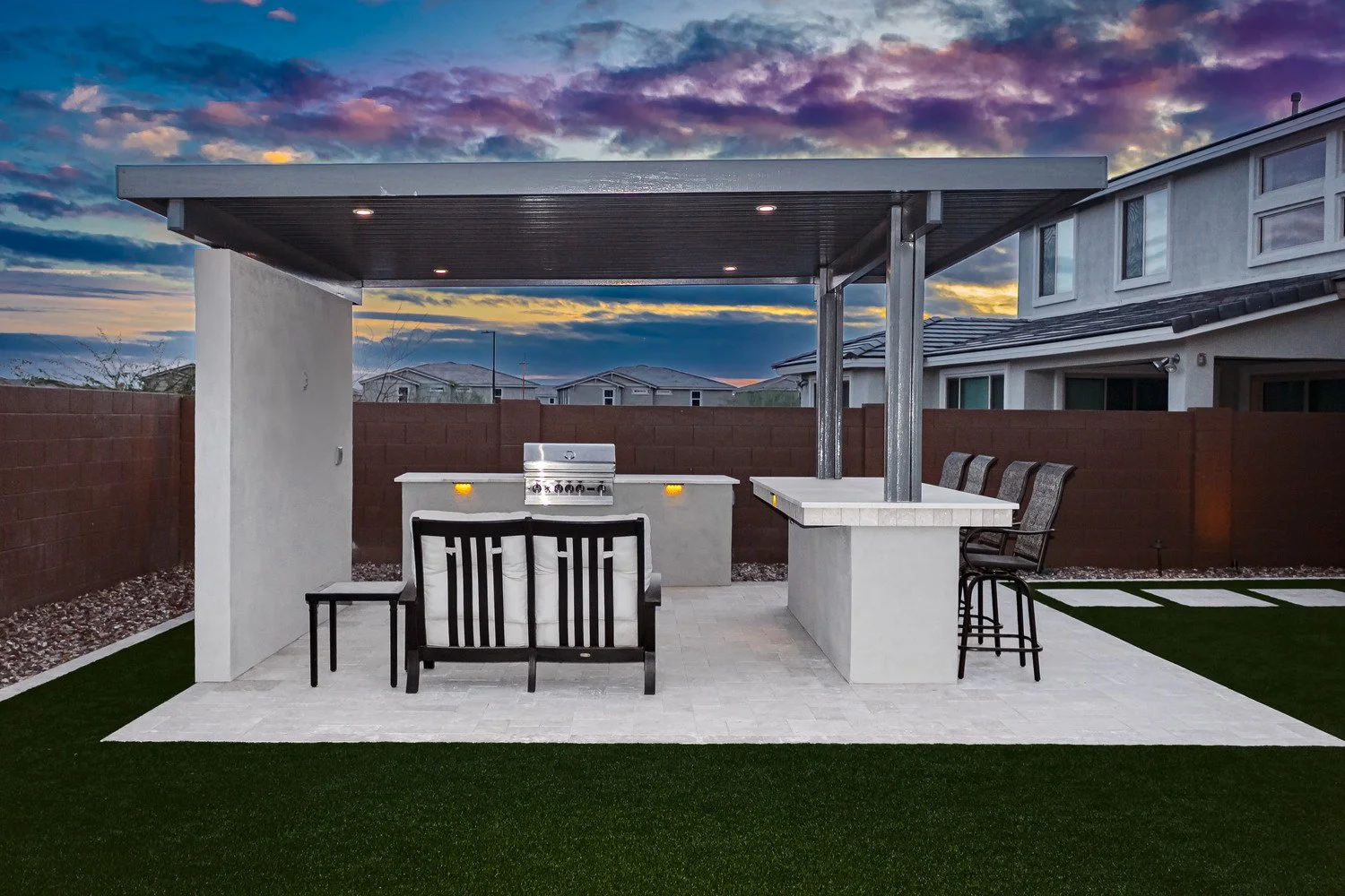 Covered outdoor kitchen in Scottsdale, AZ with outdoor kitchen appliances and outdoor lighting