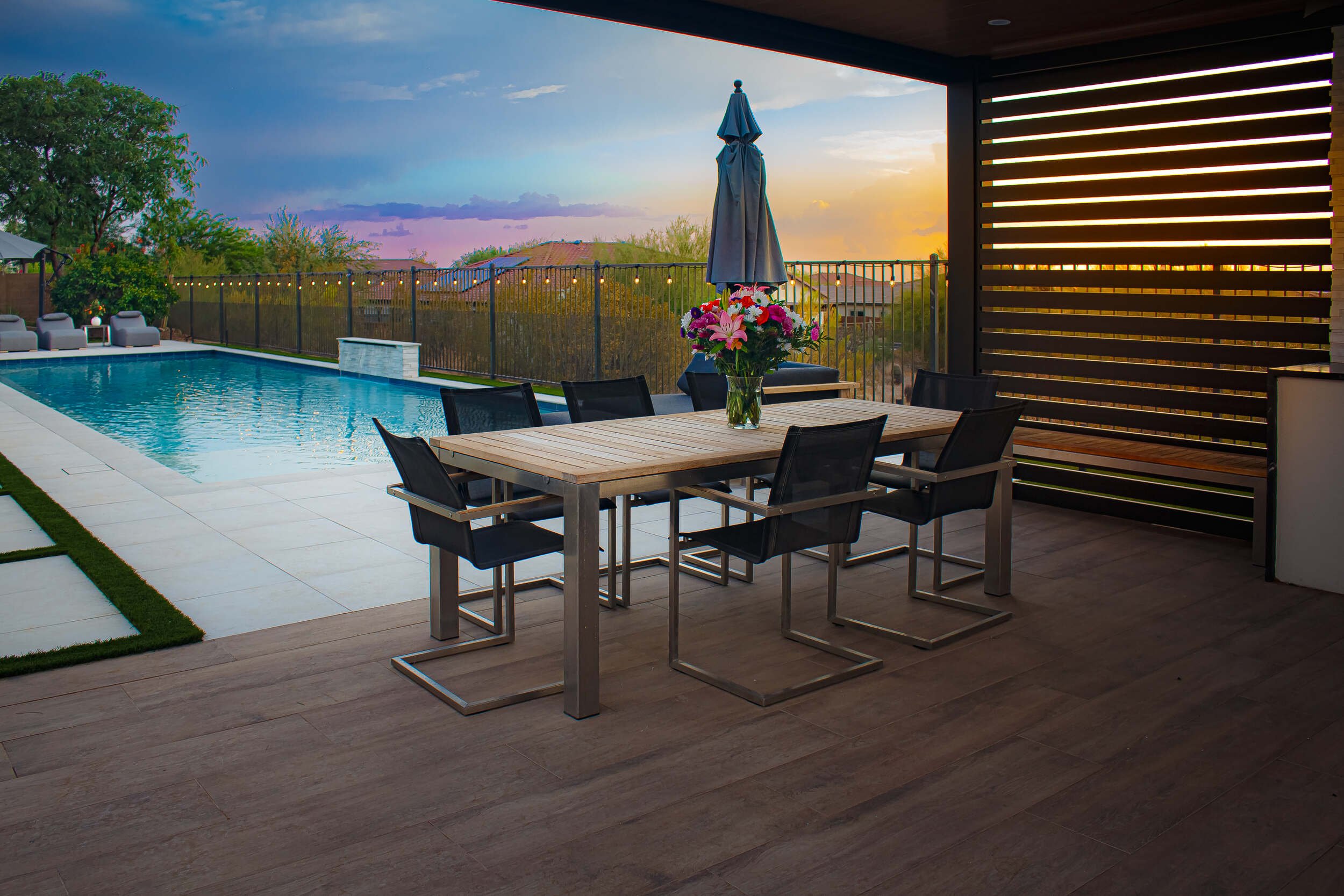 Outdoor lighting illuminating pavers and plantings in the completed backyard in Phoenix, AZ