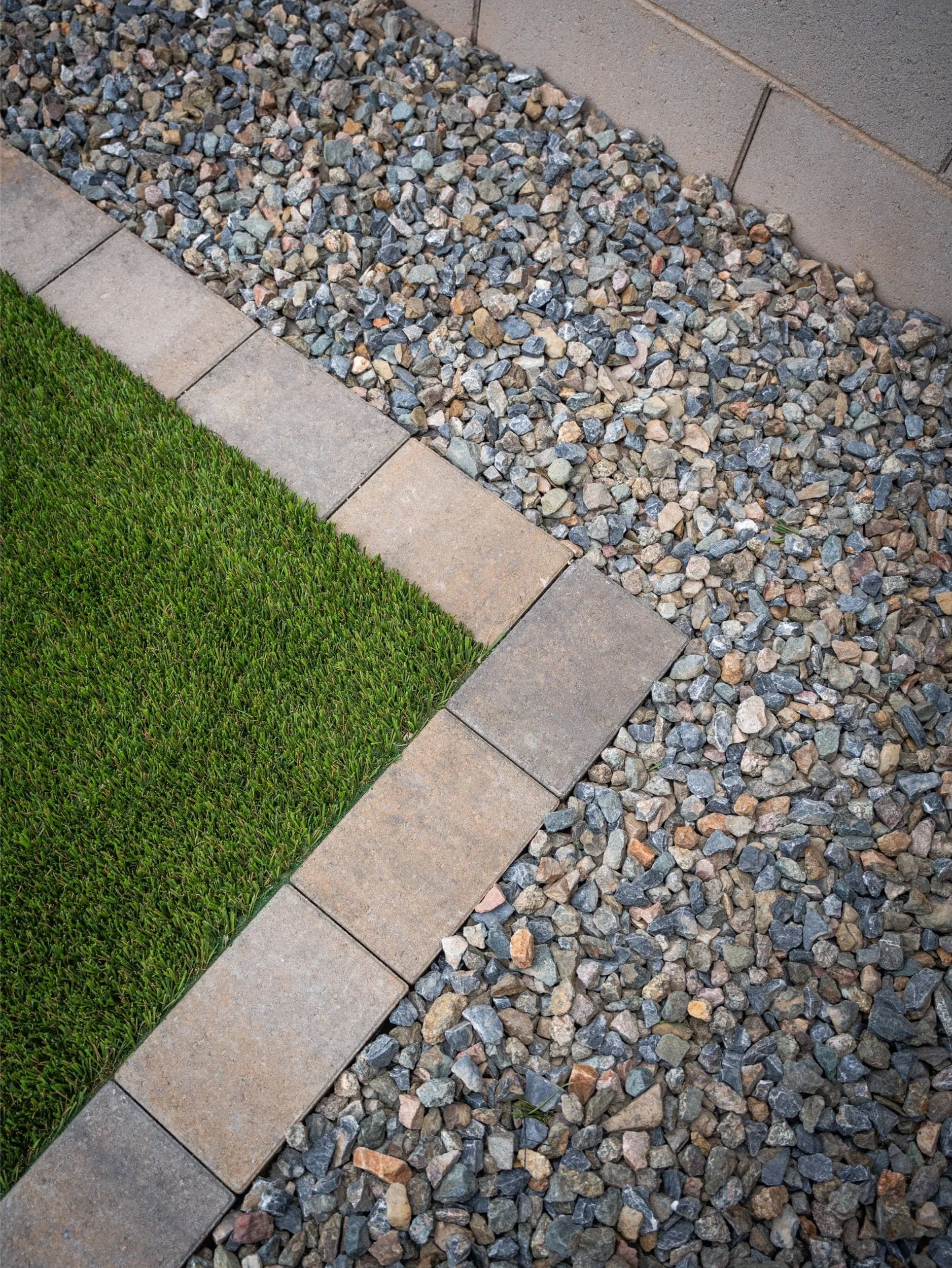 artificial turf installation along modern paver border in Vistancia, AZ