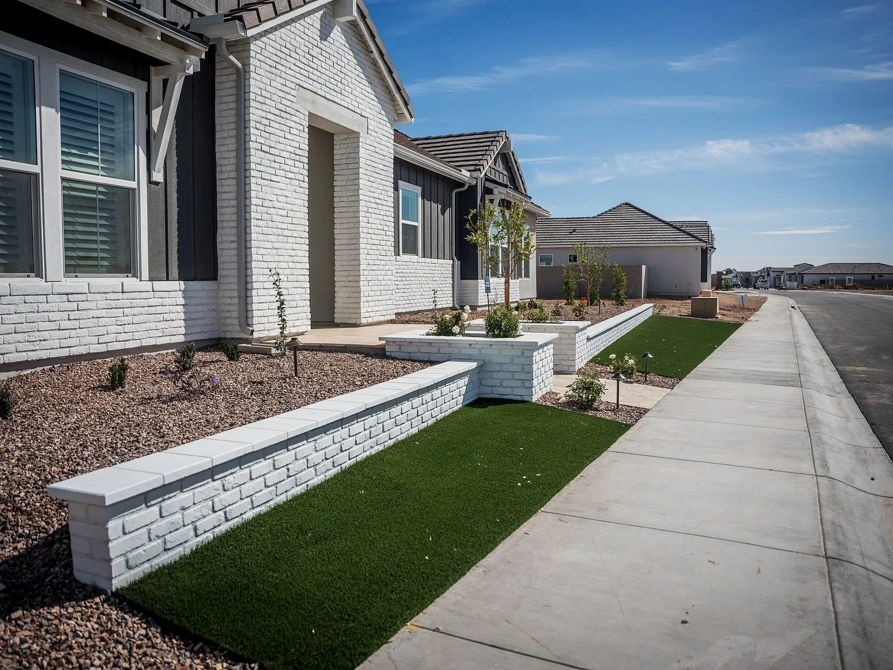 artificial turf installation bordered by plantings at an Avondale, AZ residence
