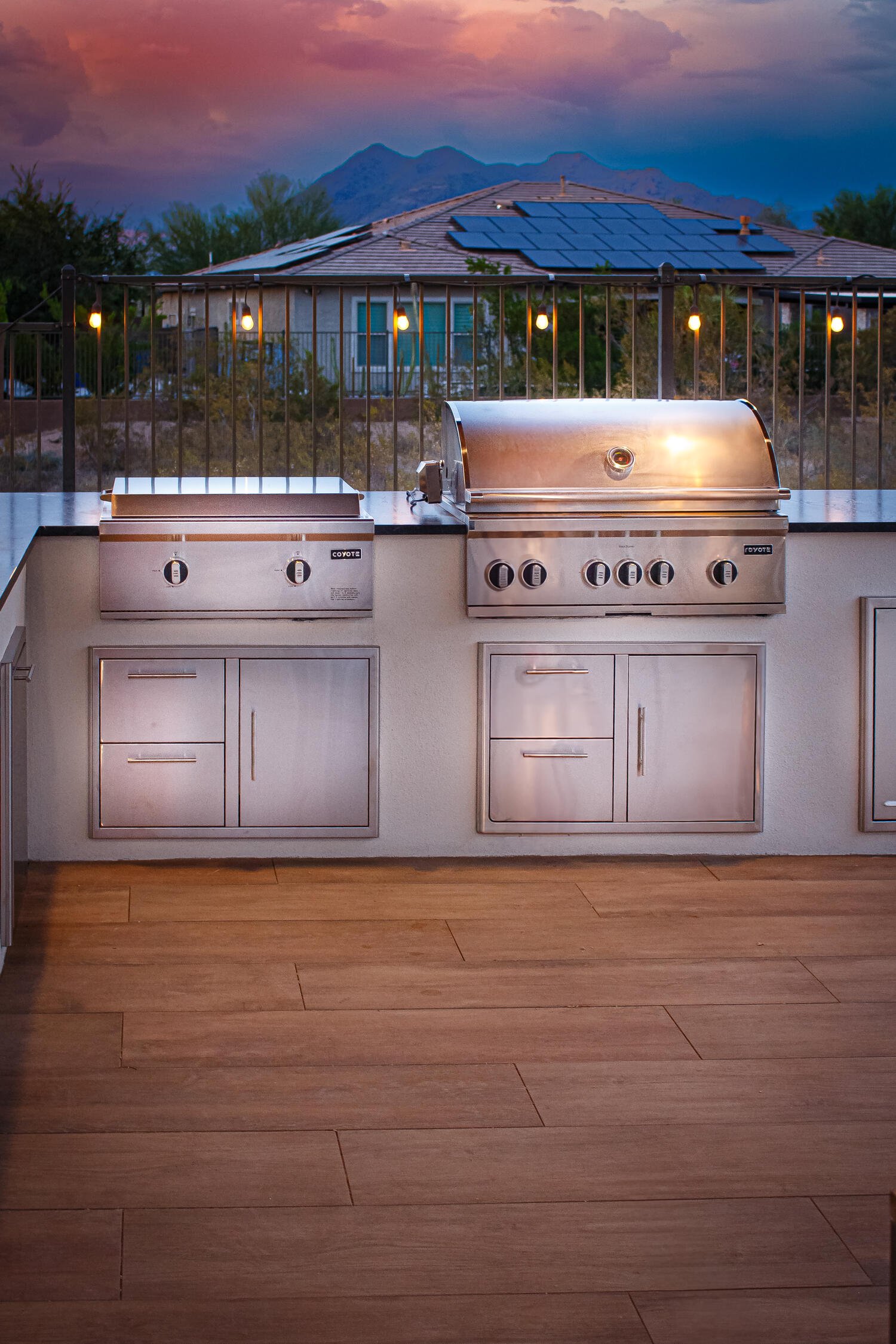 outdoor kitchen in Scottsdale, AZ with pergola roof, bar seating and outdoor lighting