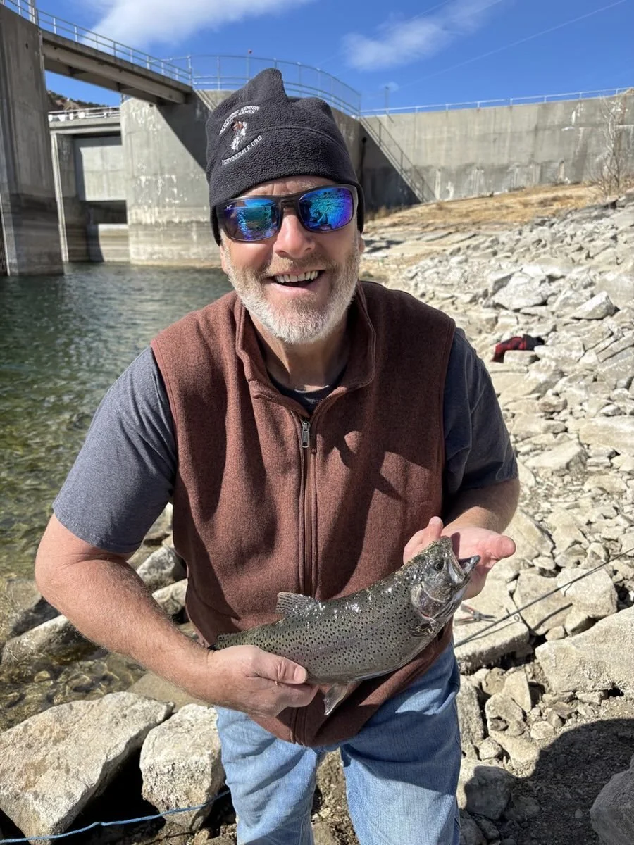 Founder Eric holding a flounder fish he caught with his hook line and sinker