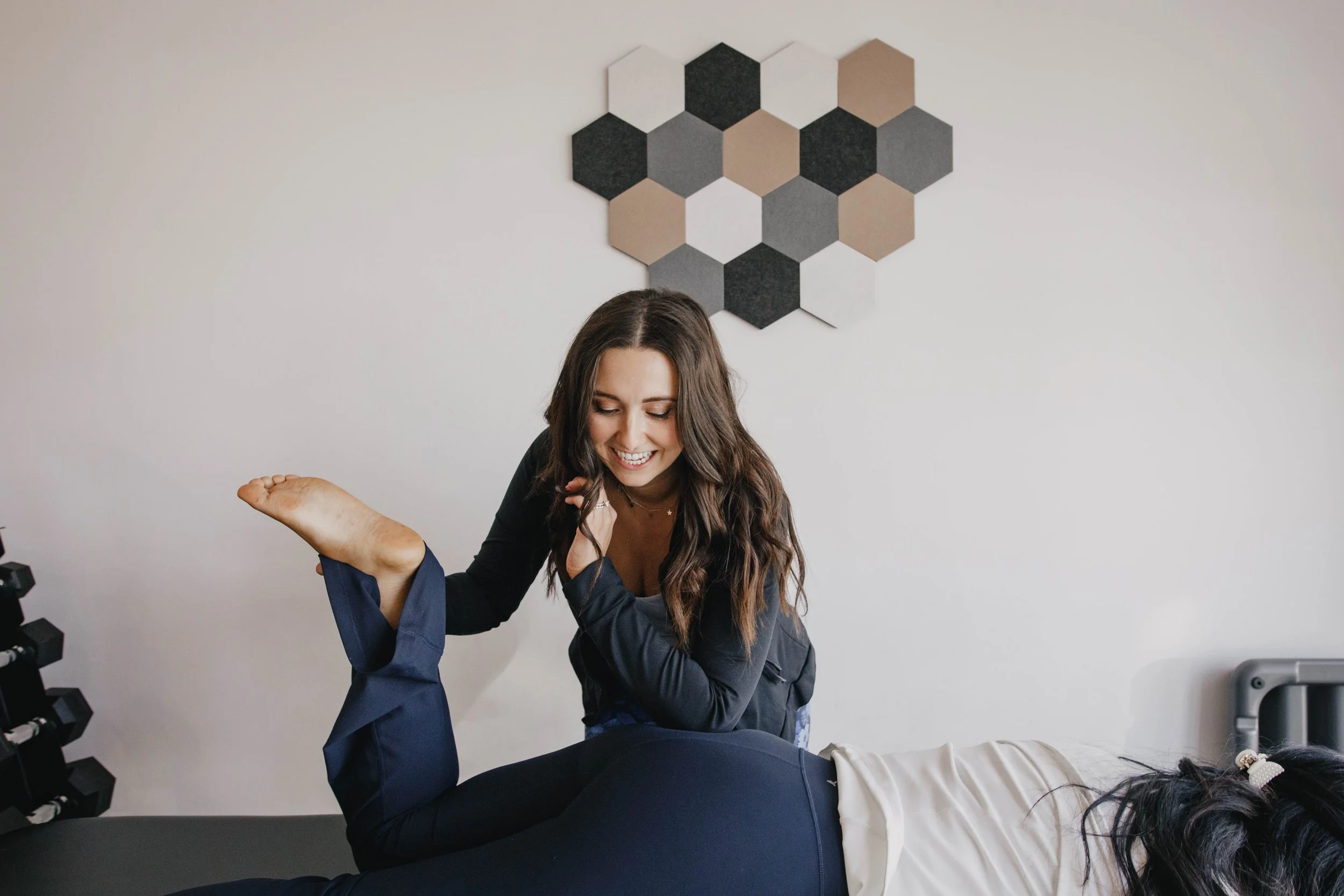 Pelvic floor physical therapist working on a patient's glutes.