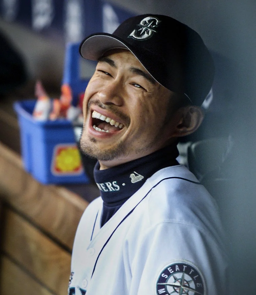Seattle Mariner Ichiro Suzuki smiles in the dugout before the start of a game against the Cleveland Indians in 2002.