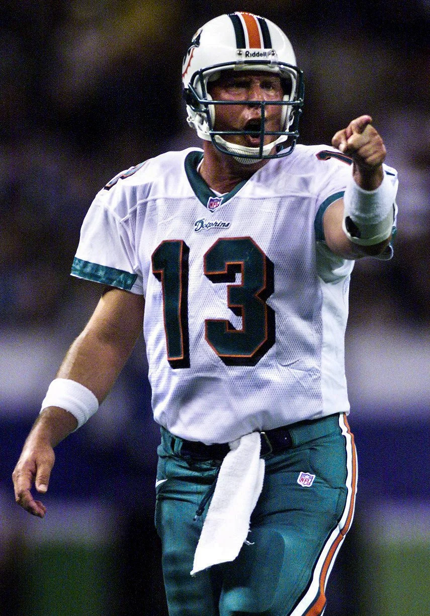Miami Dolphins quarterback Dan Marino celebrates after a touchdown to defeat the Seattle Seahawks in an AFC playoff game. This was the last Seahawks game played in the Kingdome, and Dan Marino's final victory before retirement.