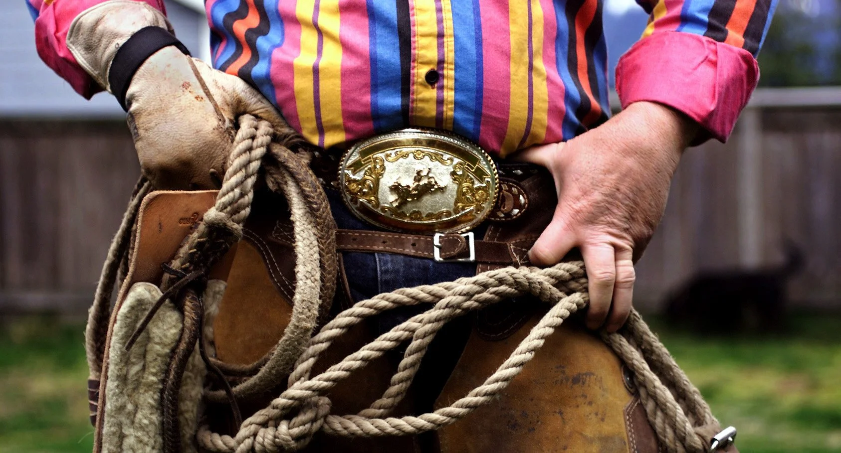 Gold Bar resident Ken Catron proudly wears his 1980 Military National Finals Bull Ridding Championship Belt buckle, along with the rest of his riding gear. In the rodeo circuit a large buckle is refered to as a “dinner plate” because it is large enou