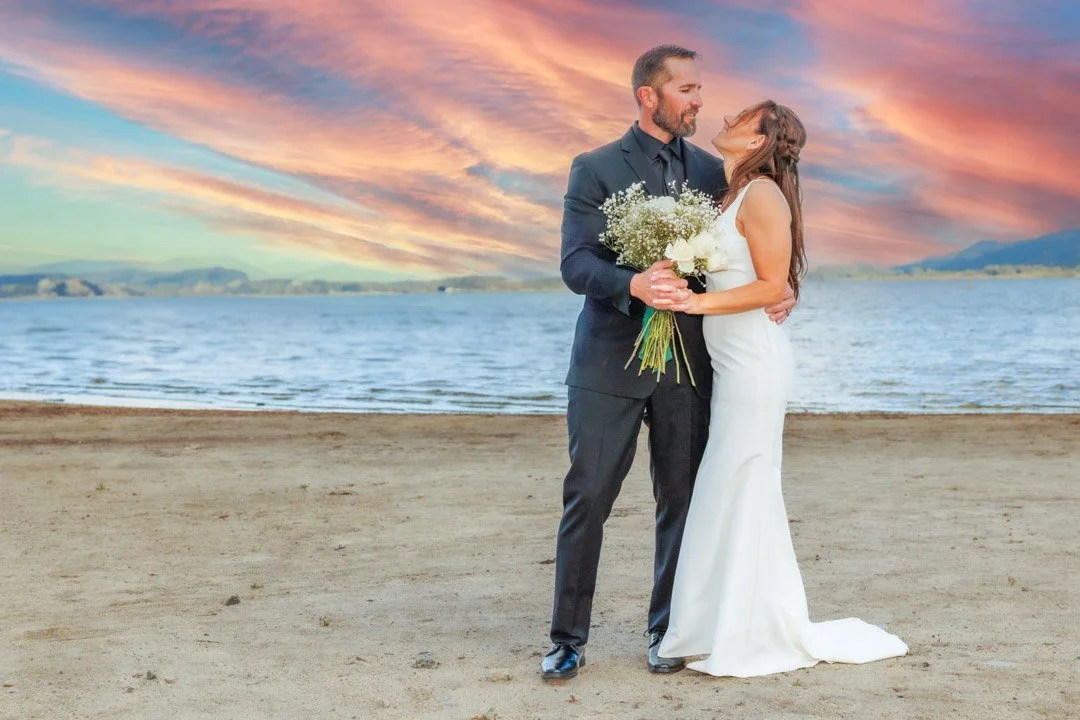 A groom looking at his bride at lake Elsinore ceremony