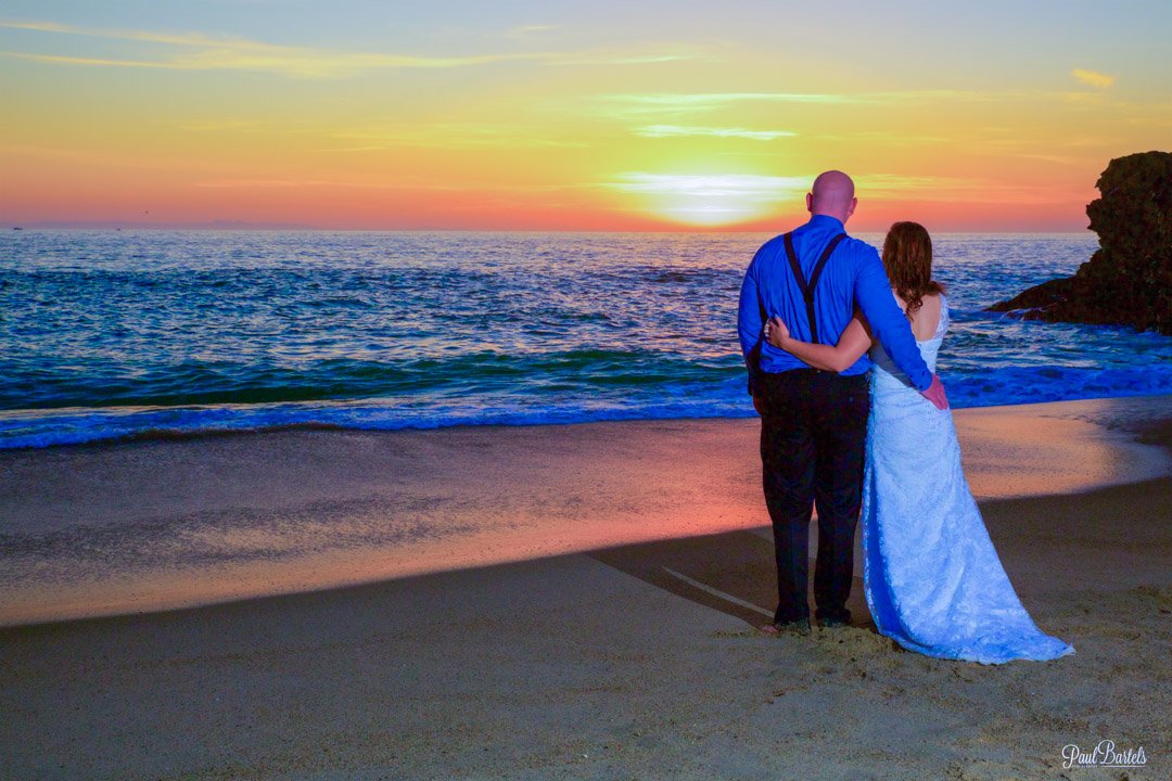 A couple after their wedding looking at the sunset over the ocean in Laguna Beach, California photograph by Paul Bartels.jpg