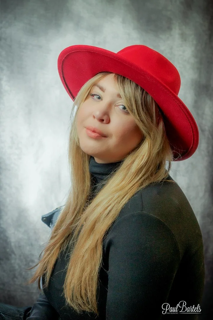 Pretty lady with a red hat, getting her head shot done at studio.