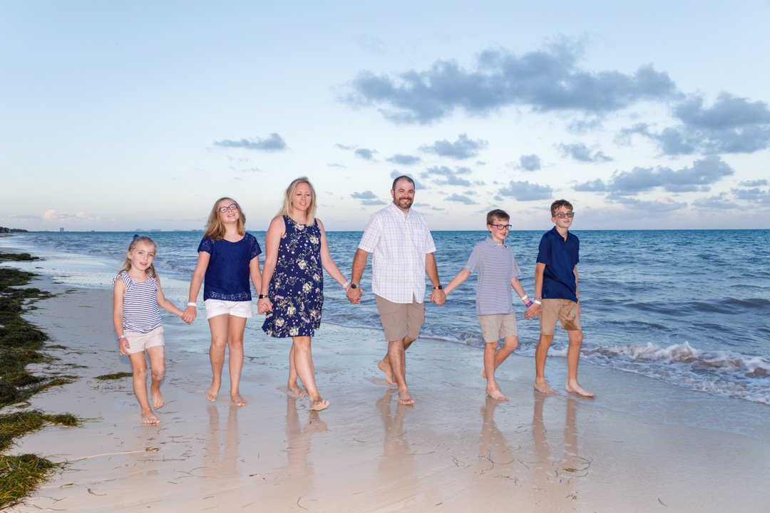 A family walking the beach in Cancun Mexico