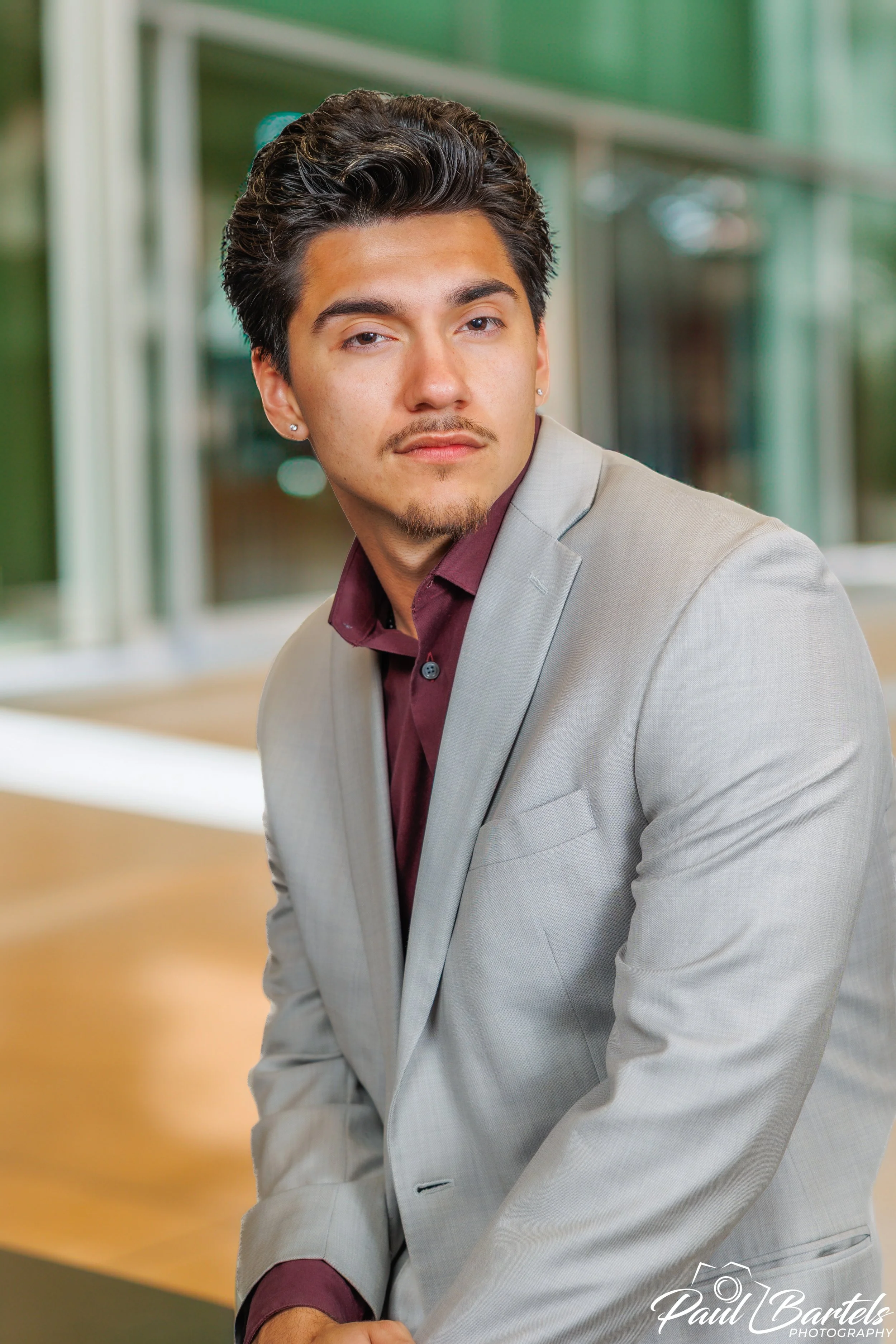 Headshot of a good looking young man in a suit.