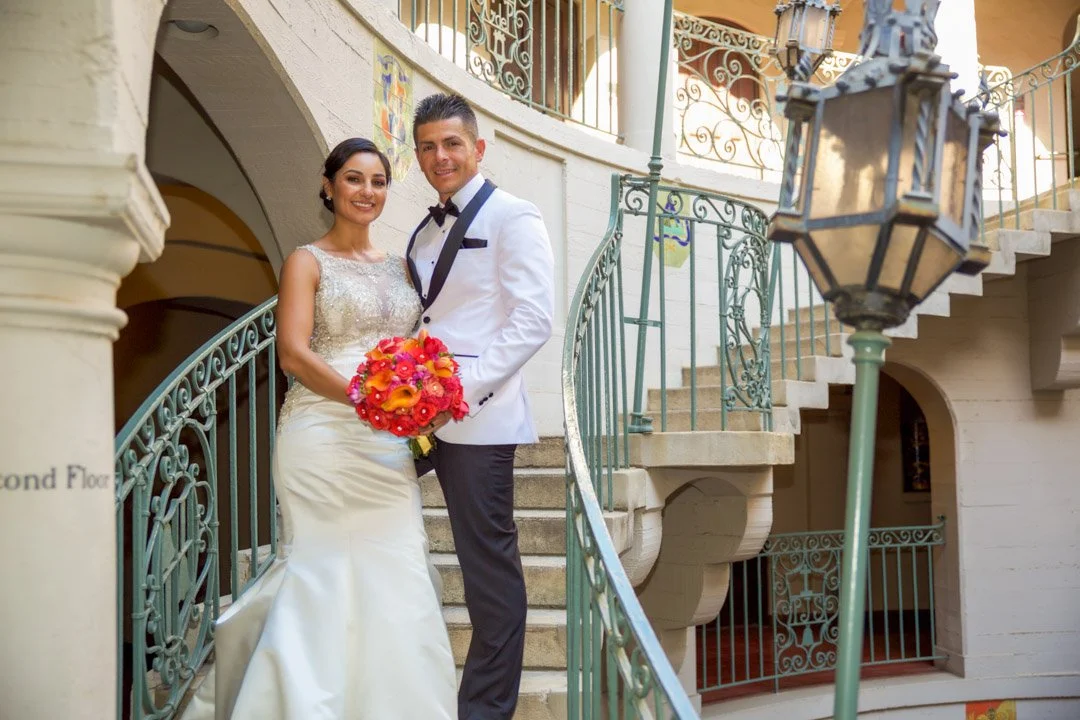 A couple taking a picture of the Mission Inn in California