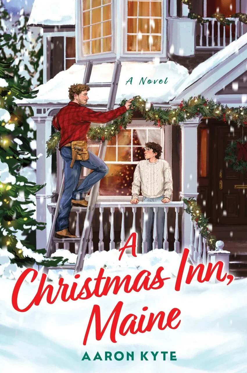 Book  cover for the queer holiday romcom 'A Christmas Inn, Maine' by Aaron Kyte. The cover shows a brown haired man in a cream colored sweater looking at a handsome man in a plaid shirt on a ladder, hanging Christmas garland.