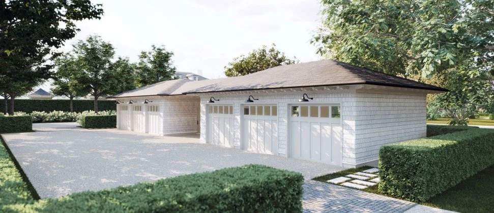 A detached garage with a gray shingle roof, white brick exterior, and four garage doors, surrounded by manicured bushes and trees. Builders in the Hamptons