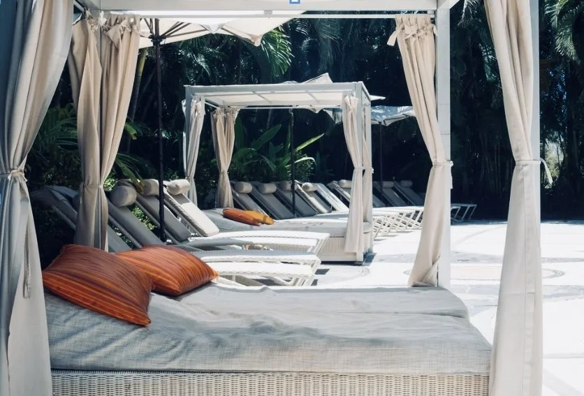 peaceful outdoor retreat space with lounge beds representing rest and restoration for mothers in the Mama Mentality community