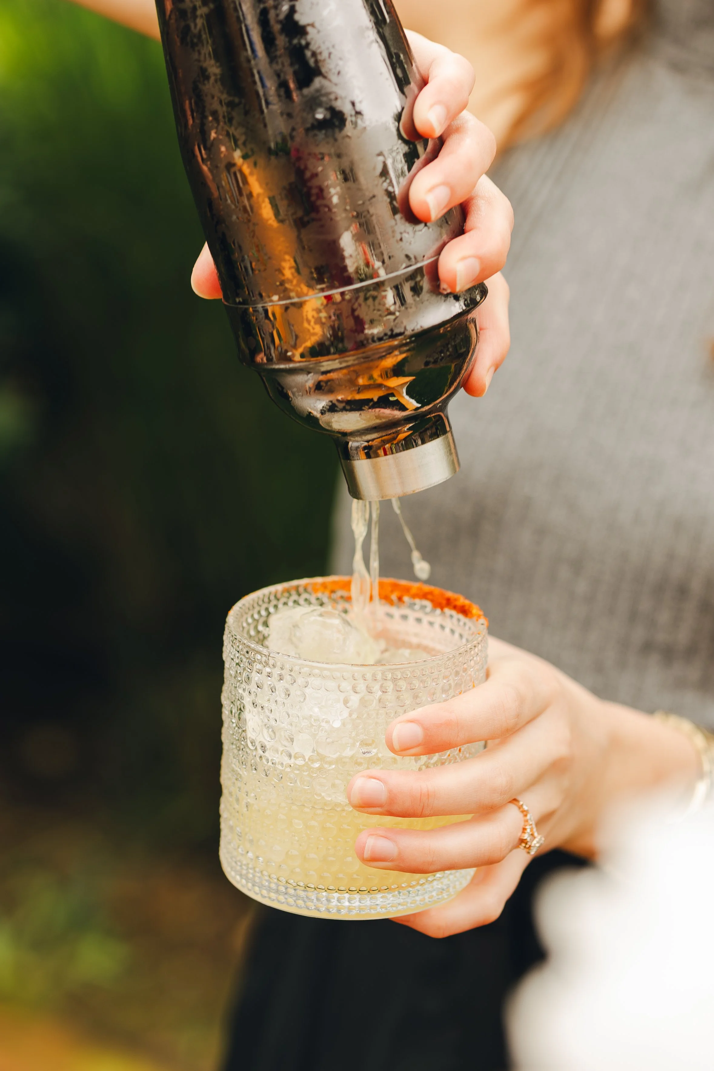 Black and white illustration of a cocktail and shaker