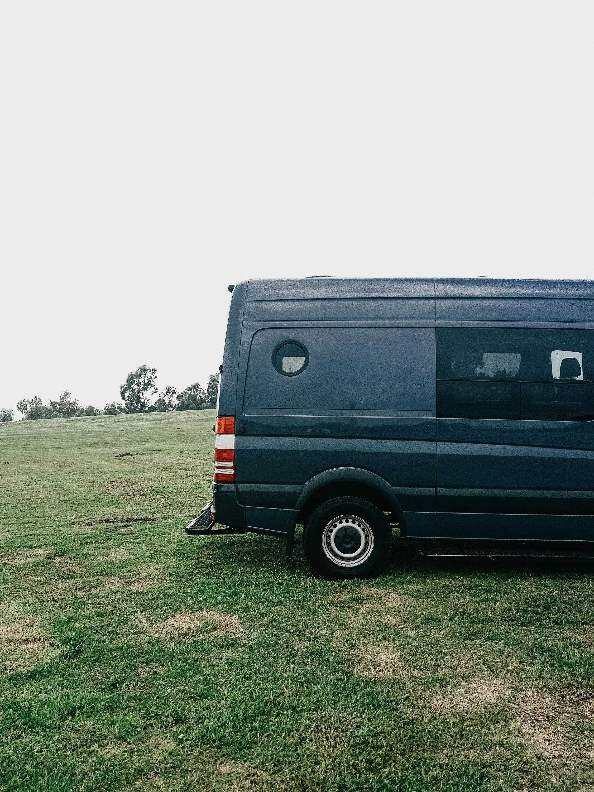 Back side view of custom van for camping with lift and custom window