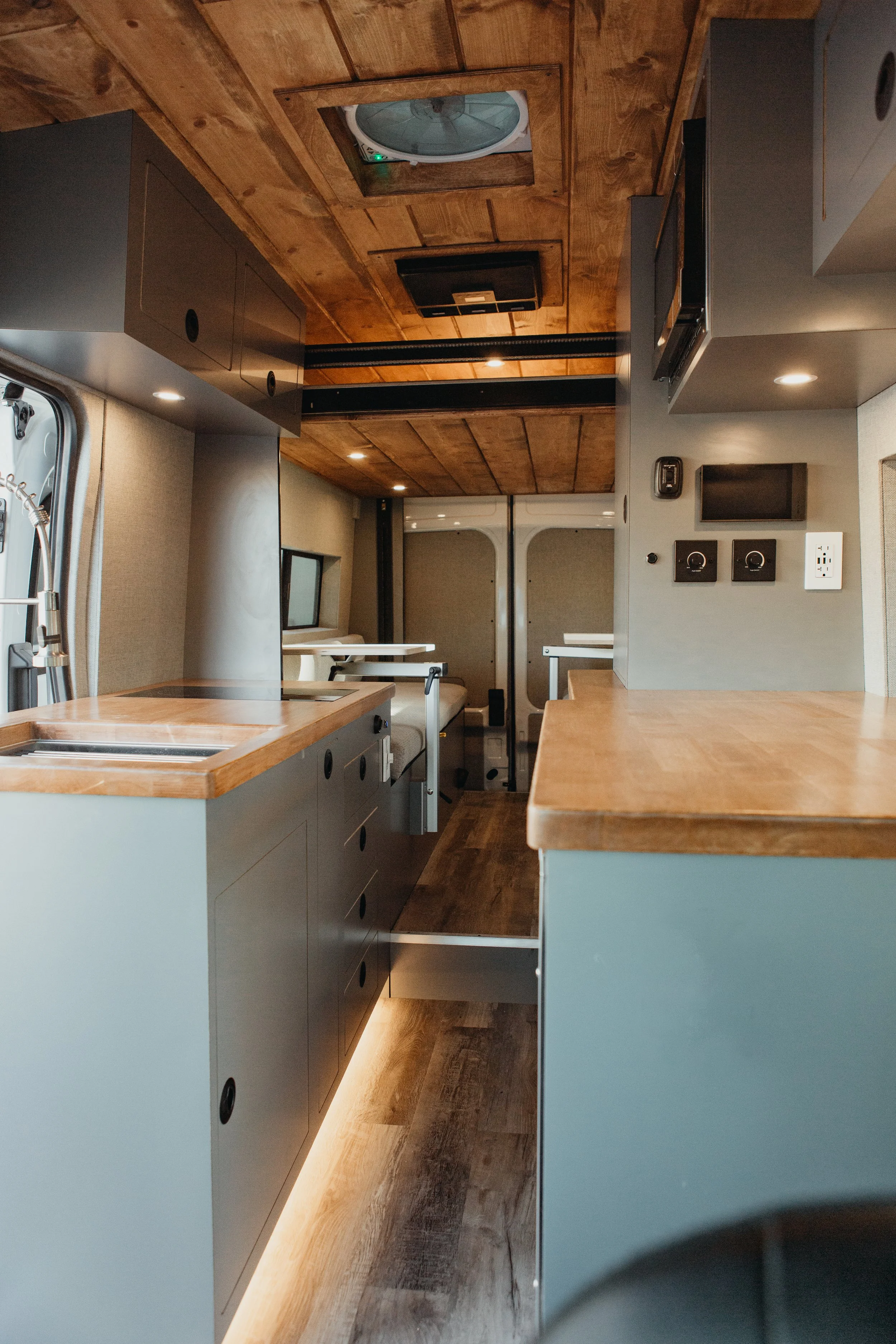 Scandinavian-Modern Sprinter conversion layout optimizing natural light and premium materials.