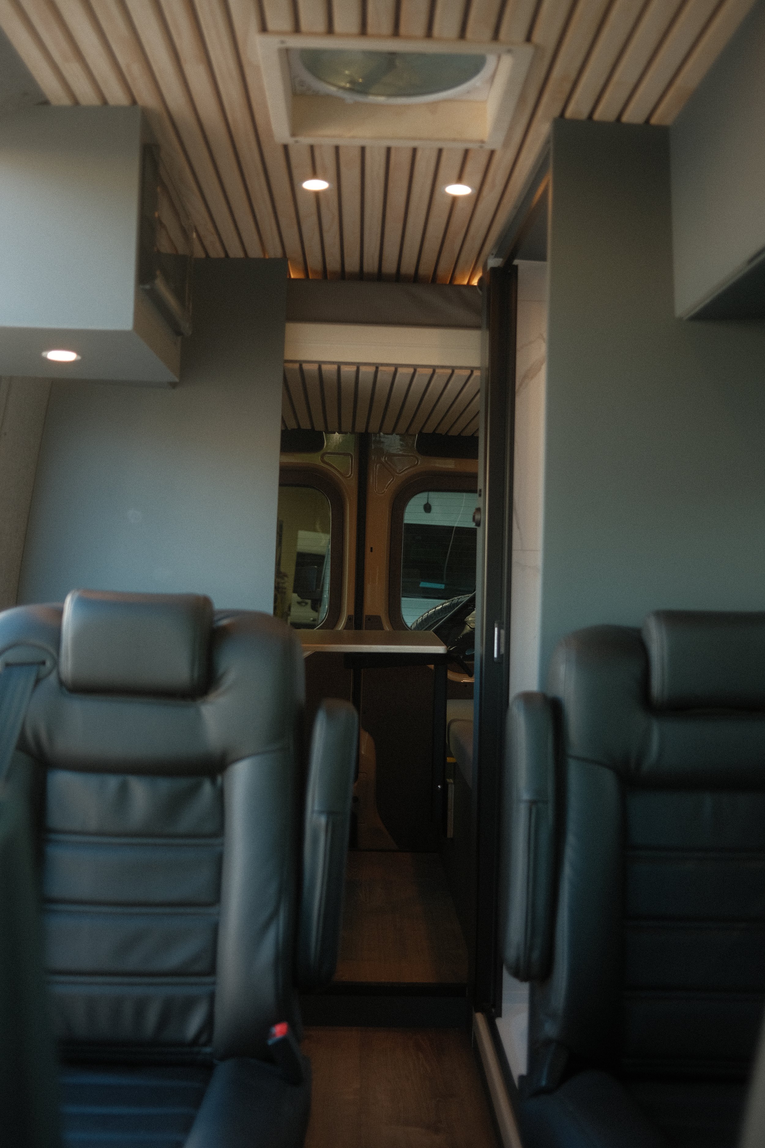 Architecturally refined camper van living space featuring sleek, seamless wall paneling perfect for traveling with family 