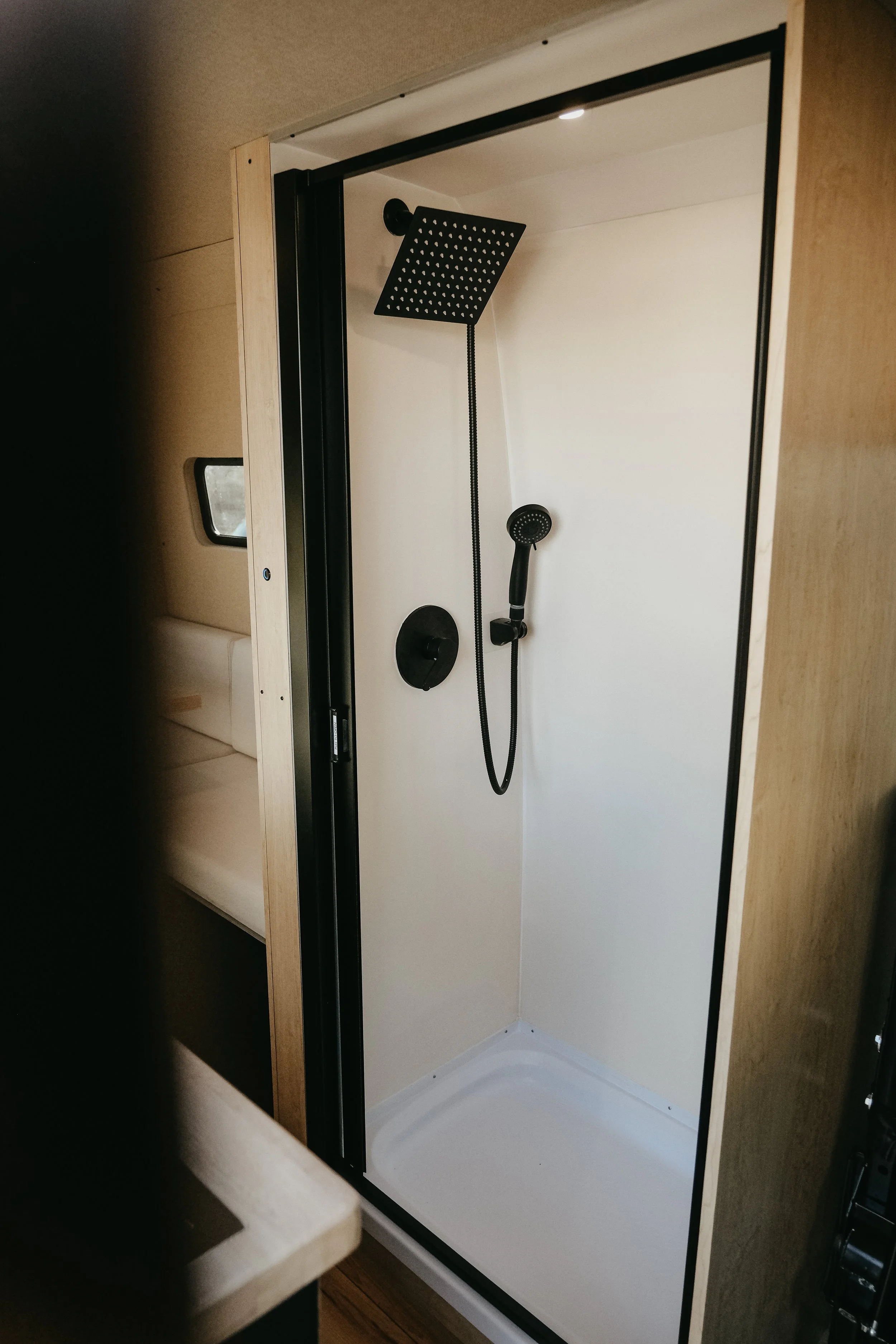 Close up of shower inside a mercedes camper van, featuring a scandanavian modern design. 