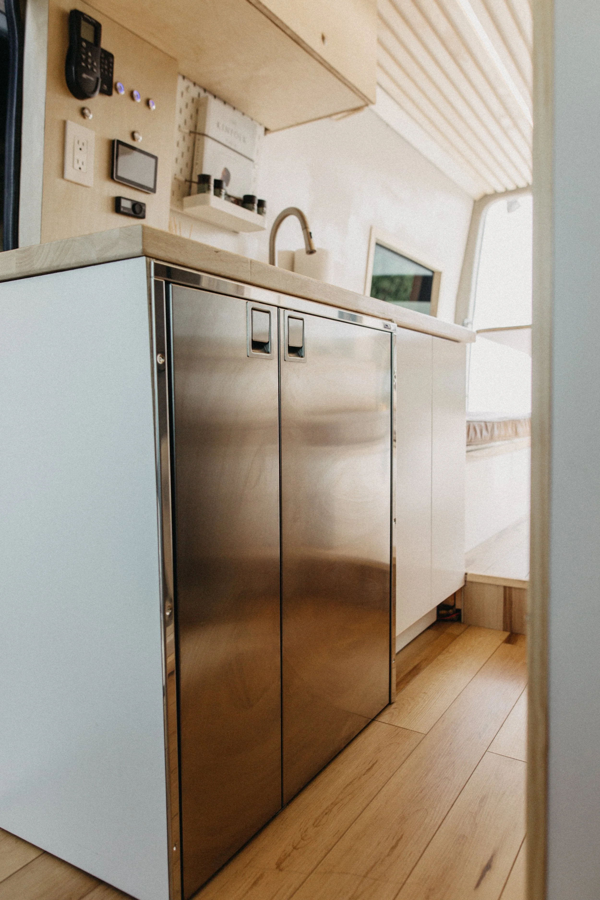 Architecturally refined Sprinter kitchen layout featuring integrated premium appliances.