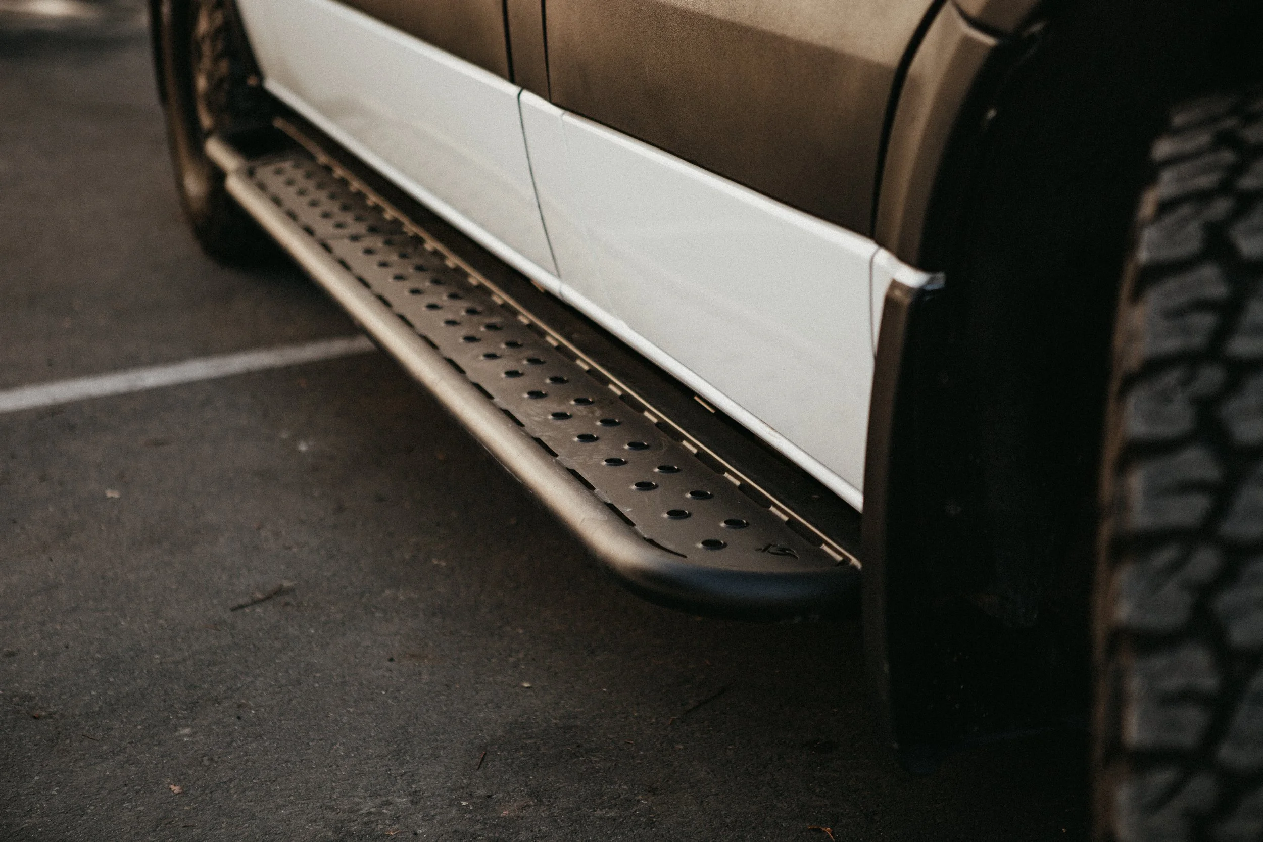 Close up view of custom side steps on a Mercedes Sprinter van
