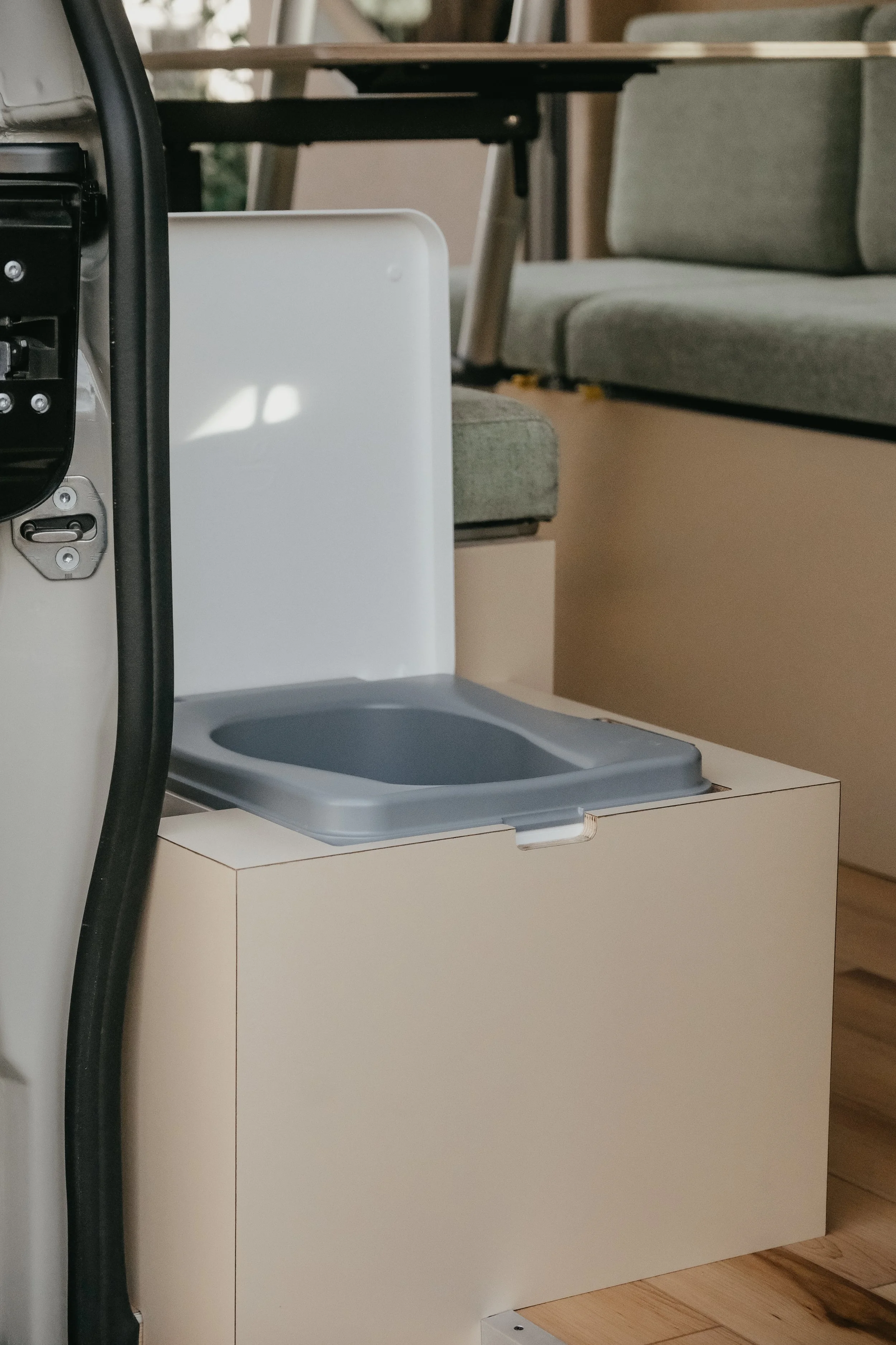Custom hidden toilet inside a scandanavian modern interior build for mercedes sprinter van