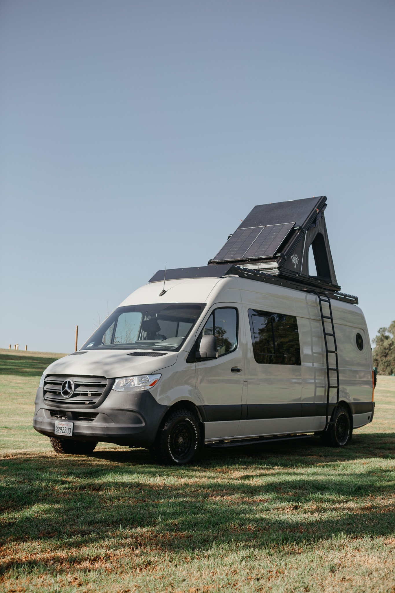 Mercedes sprinter van featuring suspension, side ladder, and pop up super pacific tent