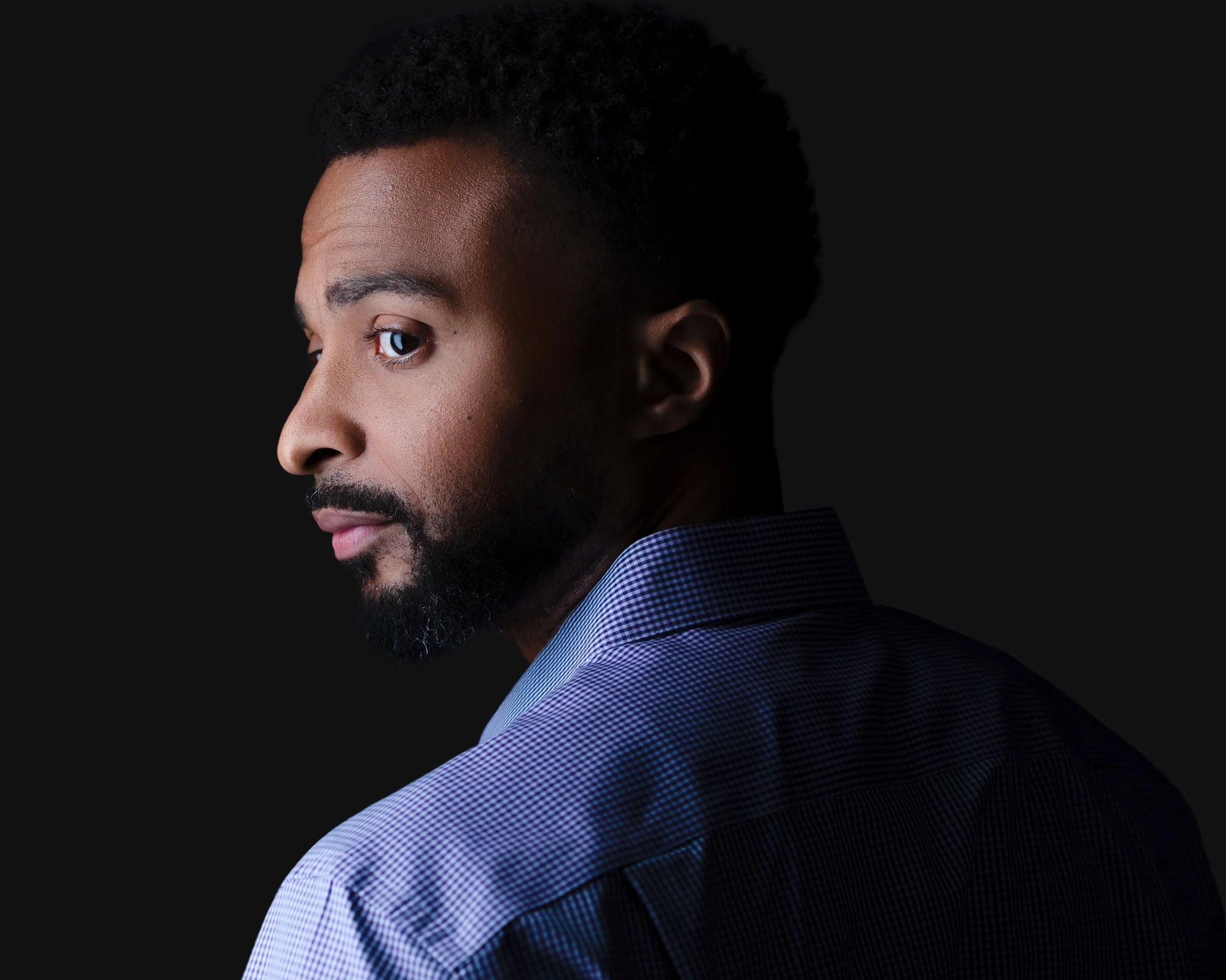 Male marketing executive headshot in NJ utilizing expert studio lighting to stand out, by Eclipse Headshots.