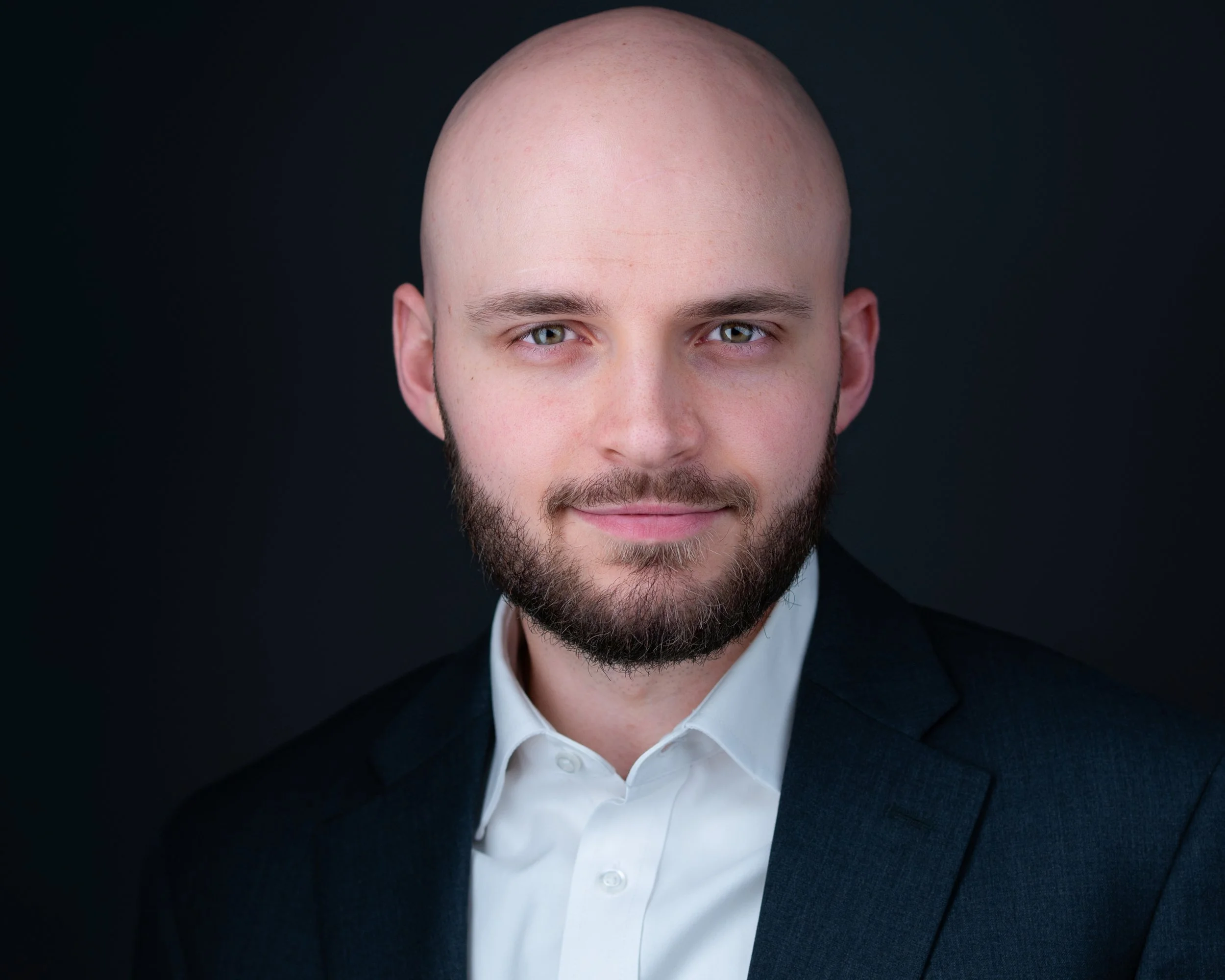 Professional business headshot of a confident executive, illustrating how high-quality photography secures a positive first impression in the critical 100 milliseconds before a client speaks.
