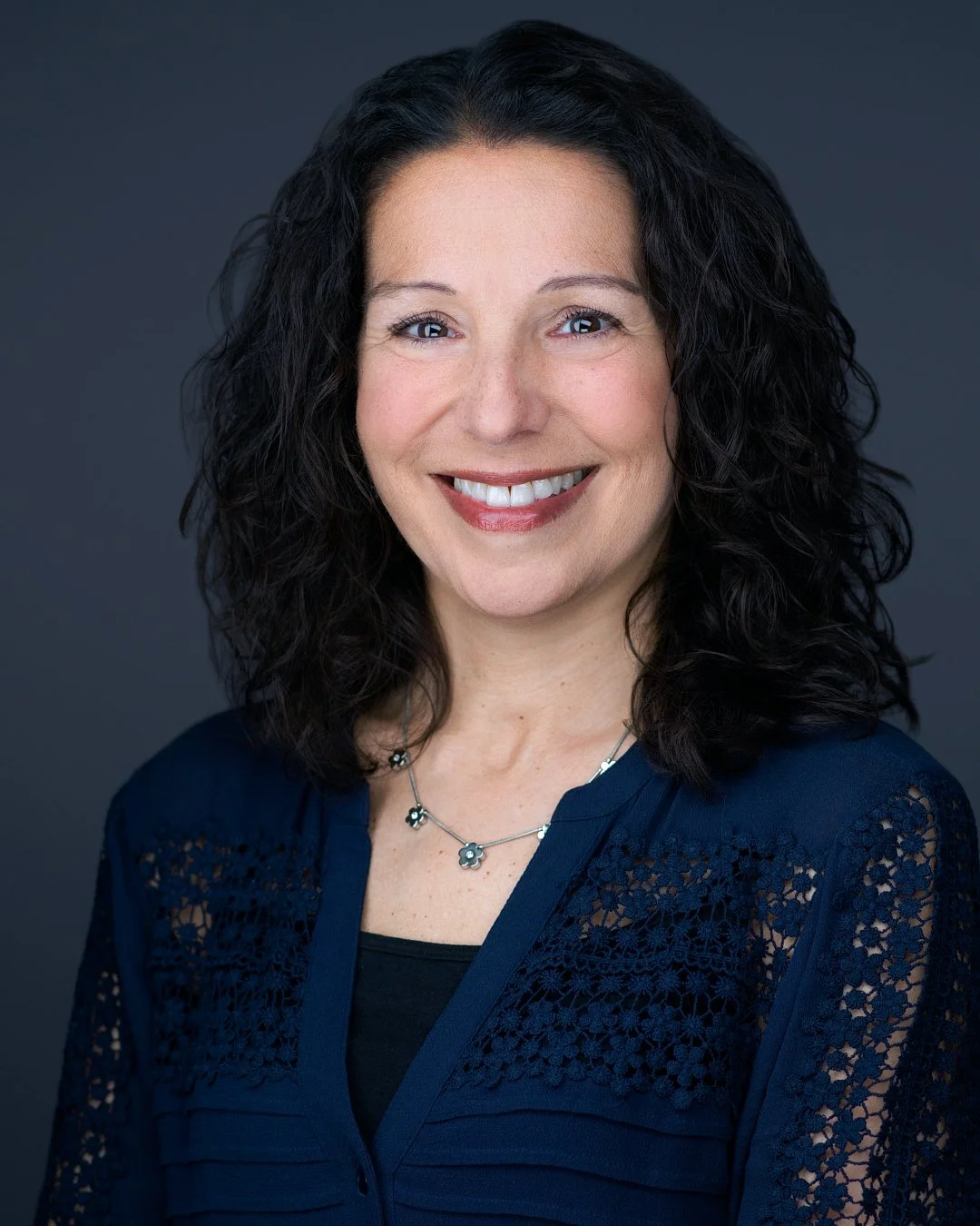 Female psychologist and clinical director, approachable smile, professional headshot by Eclipse Headshots, on-location Paramus NJ
