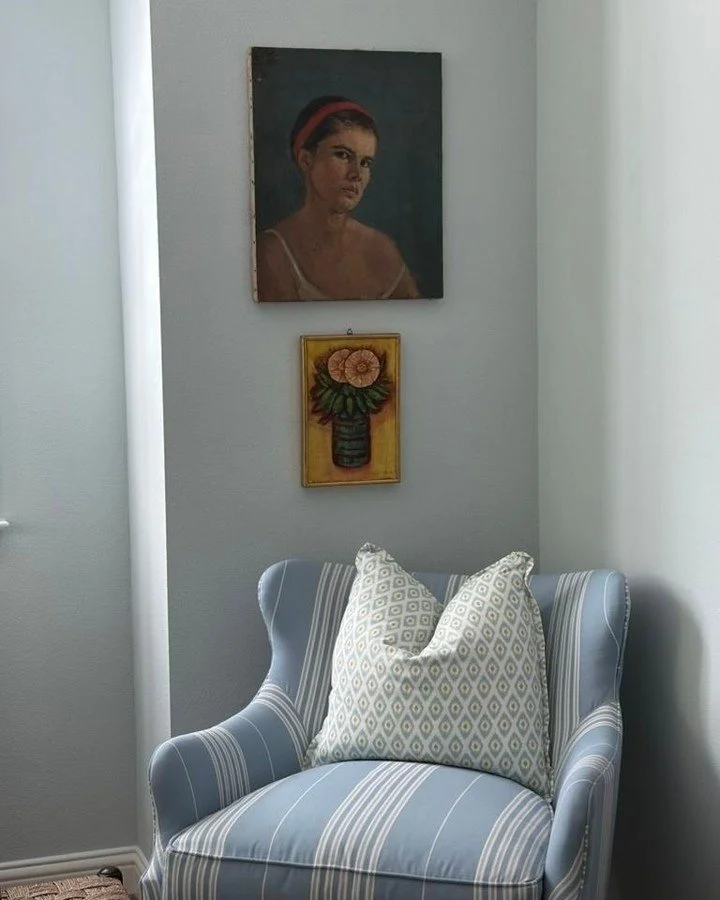 Art in layers. Contemplative portrait above a warm floral still life&mdash;different styles, complementary palettes. Collected over time beats matchy-matchy every time.

Top:
Girl With The Red Headband
Unsigned
Oil on canvas 16 W x 20 H
$465

Bottom: