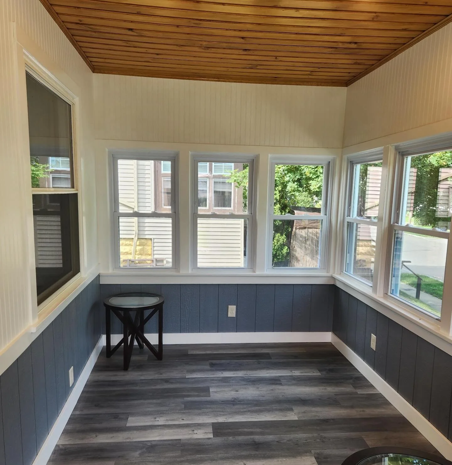 Spring is the perfect time to try something new, which is exactly what we did with this completely remodeled sunroom!

With brand new windows, vinyl plank flooring, afresh paneling, and a shiplap ceiling, 
we love the open, up to date feeling we were