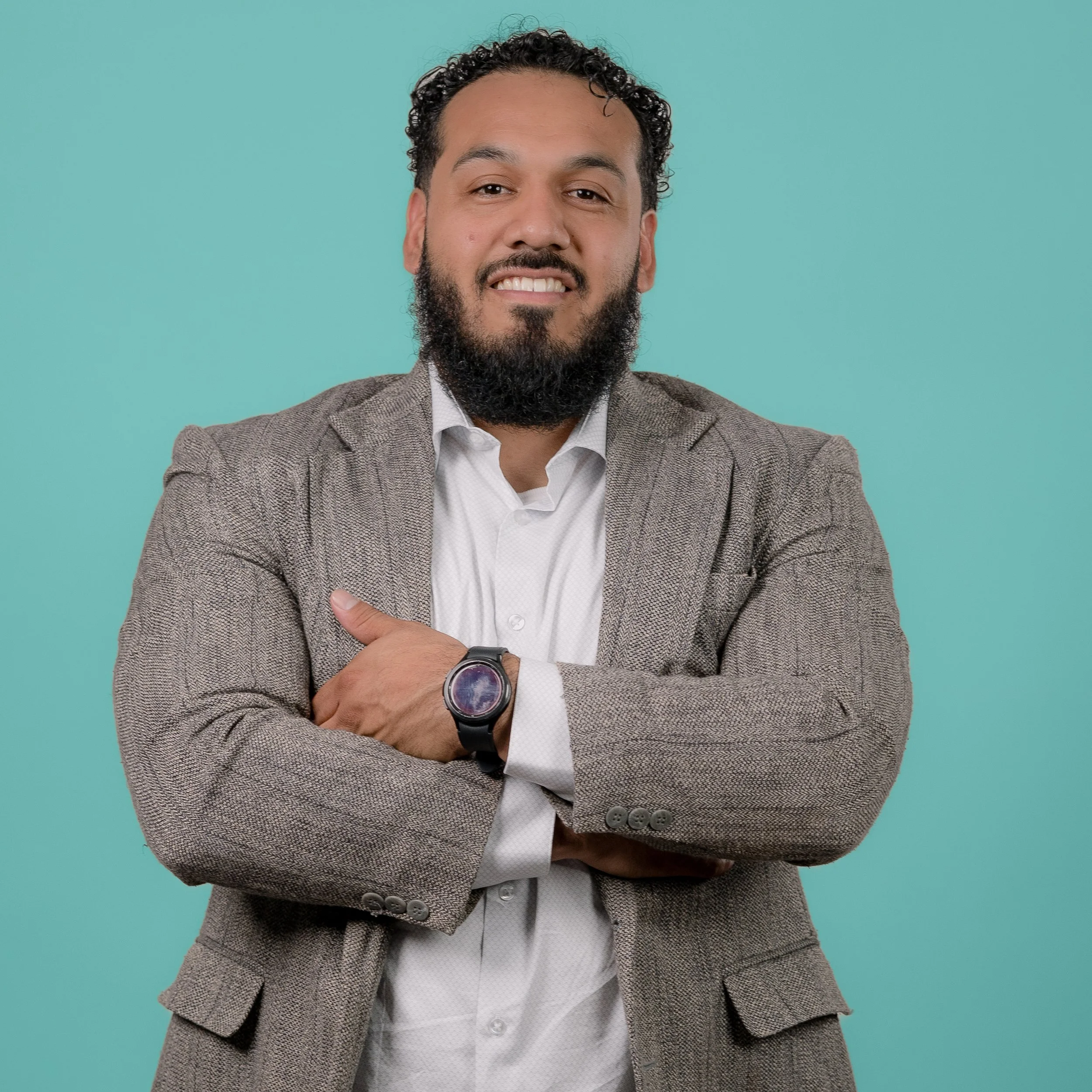 Creative professional business headshot against a teal backdrop taken at Sunset Media studio on the Central Coast