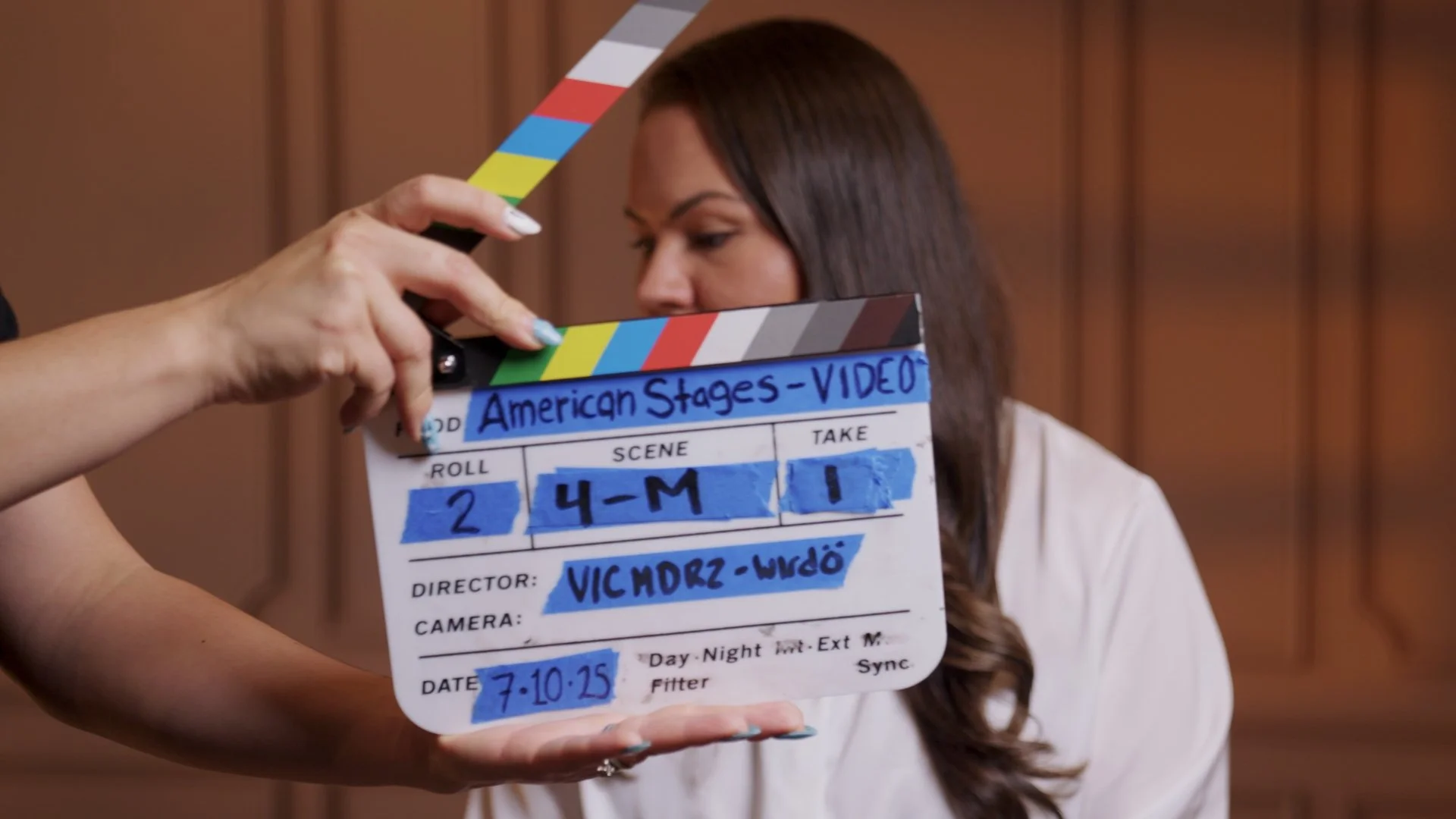 Production assistant holding a movie slate on set for a Sunset Media brand storytelling film shoot on the Central Coast