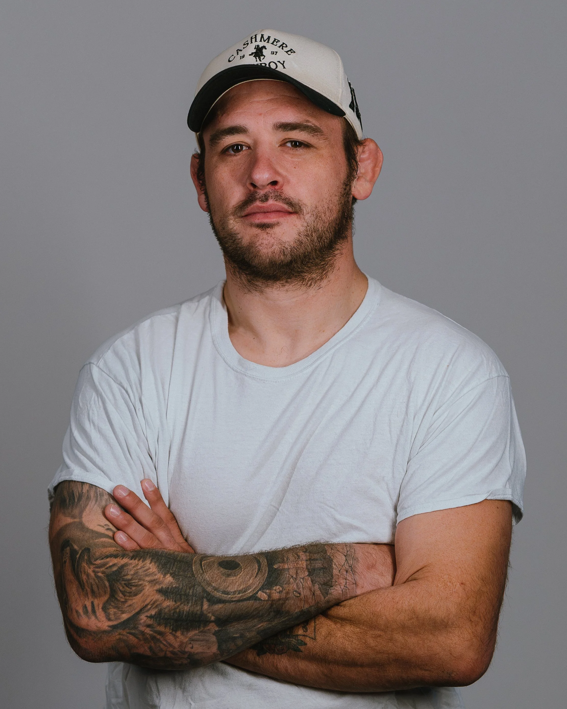 Casual studio headshot portrait of a local entrepreneur with arms crossed shot by Sunset Media
