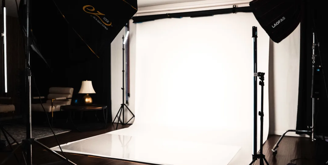 White seamless backdrop floor and studio lighting gear for commercial photo and video productions at Creative Juices Studio