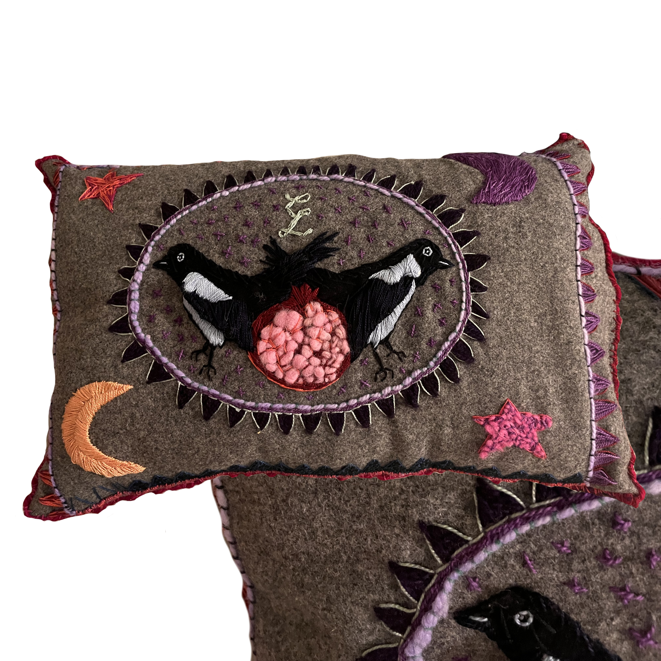Hand embroidered, wool pillow with magpies and a pomegranate
