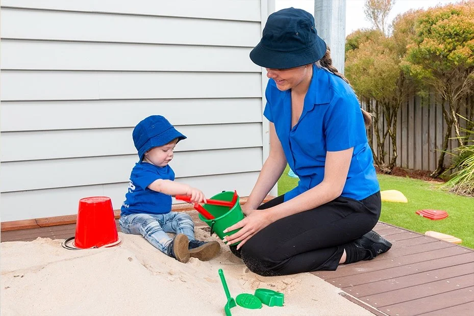 Educator and child play together in the sandpit at Highfields Central Early Learning Centre