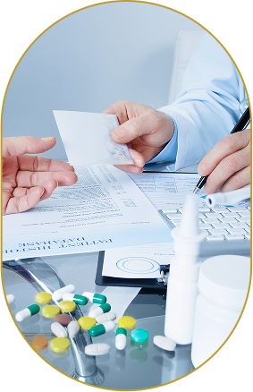 A healthcare professional handing a prescription to a patient at a desk with medication capsules, a nasal spray, and medical documents.