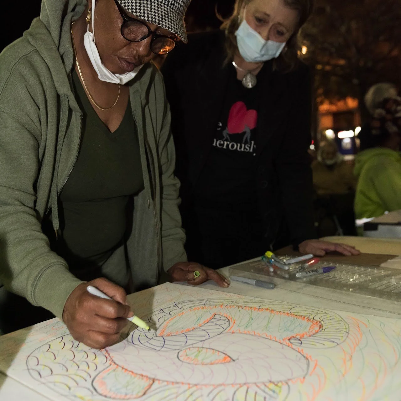 CPE Student M. Paloma Pavel (right) supporting a neighbor at the art event