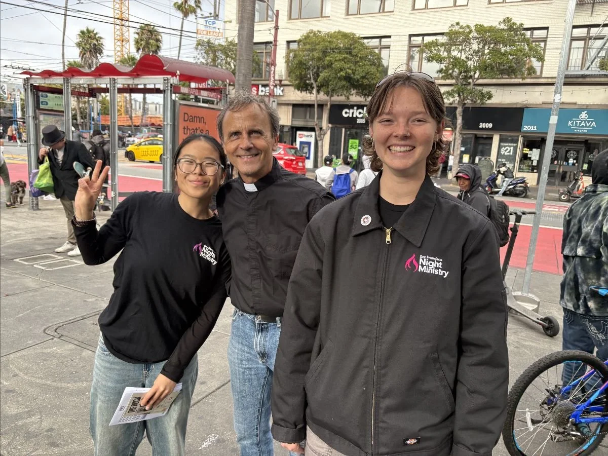 Audrey Zhou and Paige Scanlon standing with Night Minister Doug Binzak on a San Francisco street.