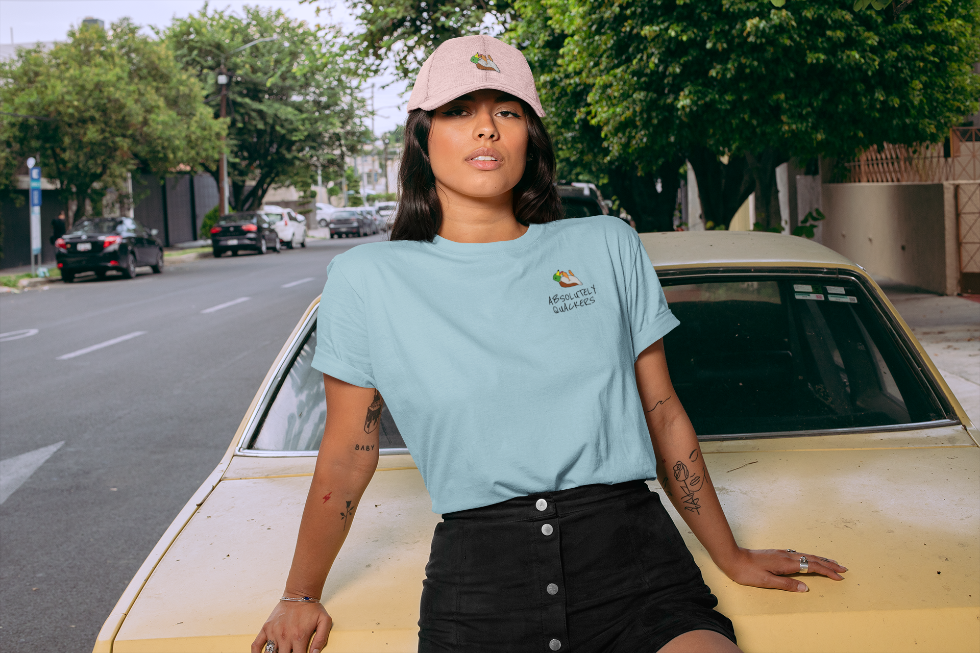 t-shirt-mockup-of-a-woman-with-a-dad-hat-sitting-on-an-old-car-28607.png