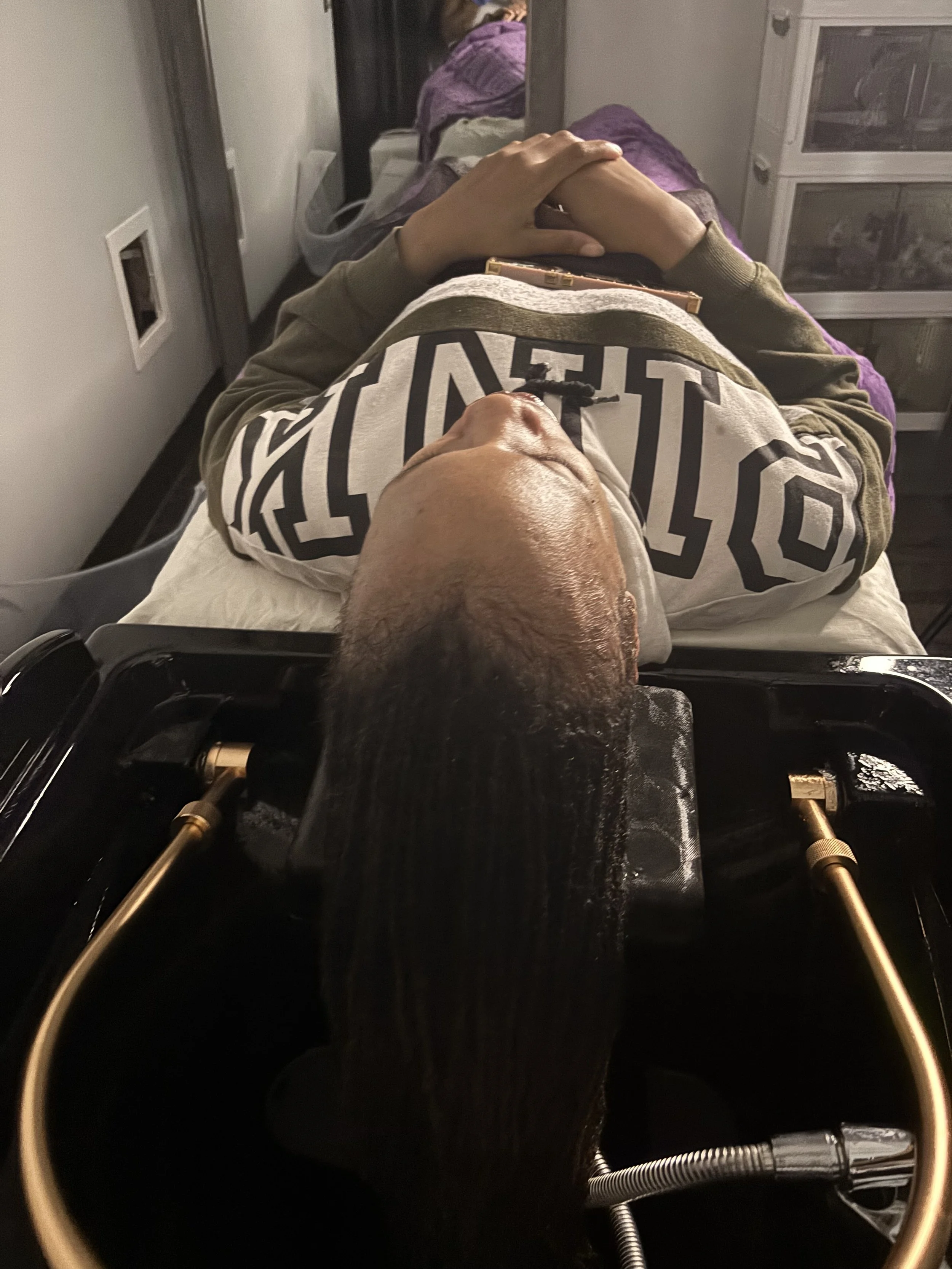 A woman receiving a head massage from a therapist in a spa or wellness center, with the brand 'CATRESENCO' logo visible in the background.