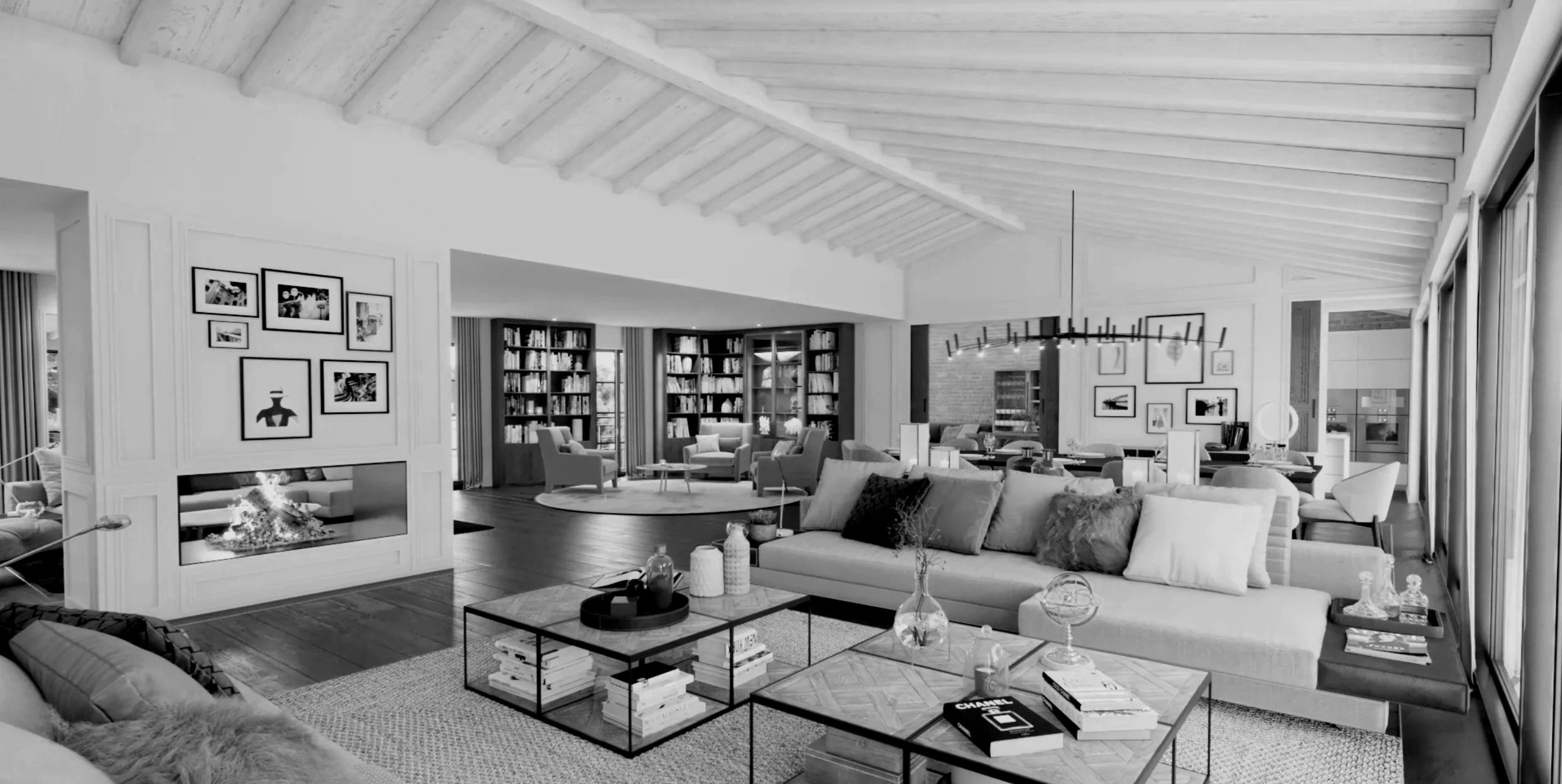 Salon moderne avec cheminée, canapé, tables basses, étagères de livres, plusieurs fauteuils, et décoration élégante.