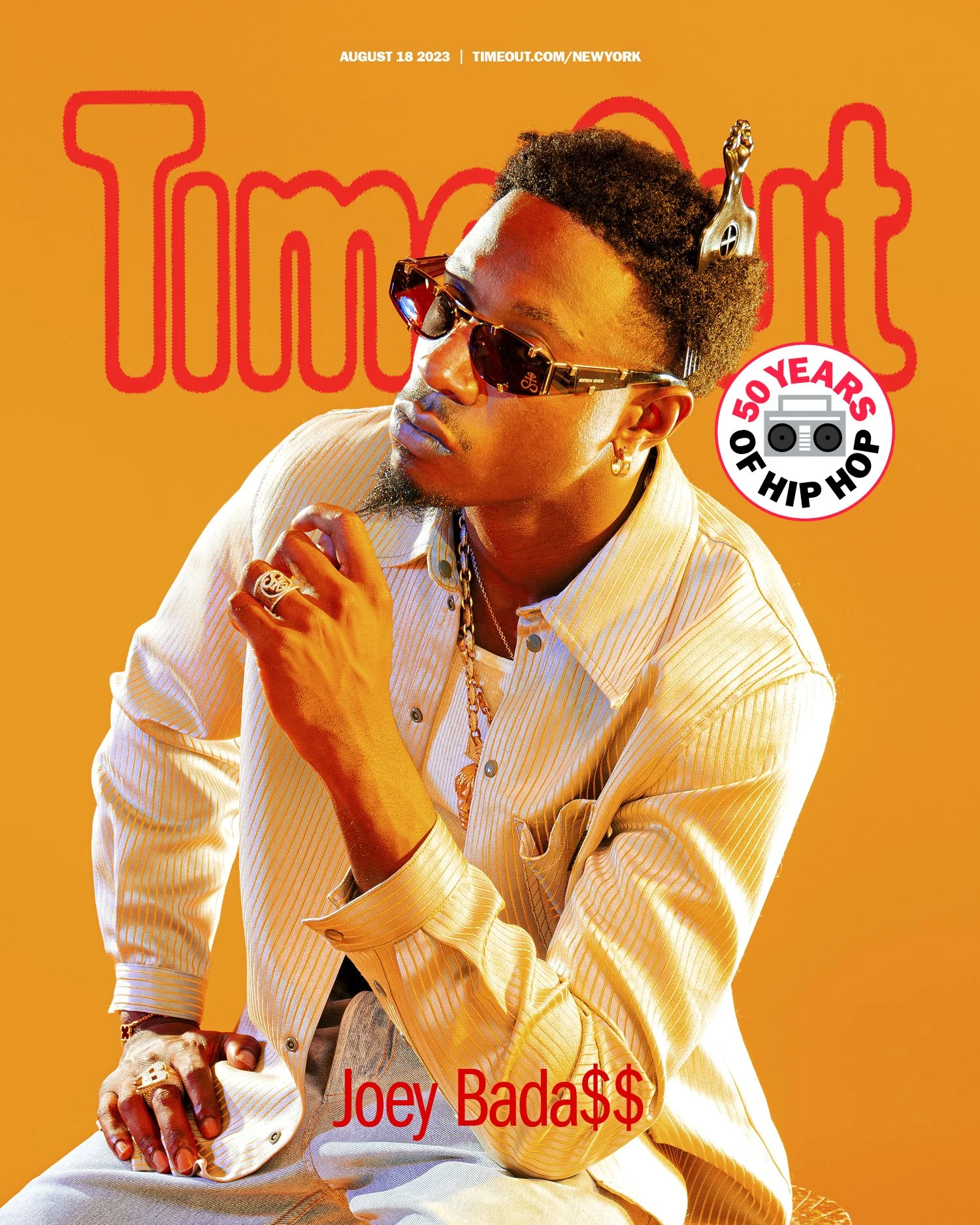 Magazine cover featuring Joey Bada$$ wearing sunglasses, rings, and jewelry against an orange background. The cover celebrates 50 years of hip hop, with the publication date August 18, 2023, and the website timeout.com/newyork.