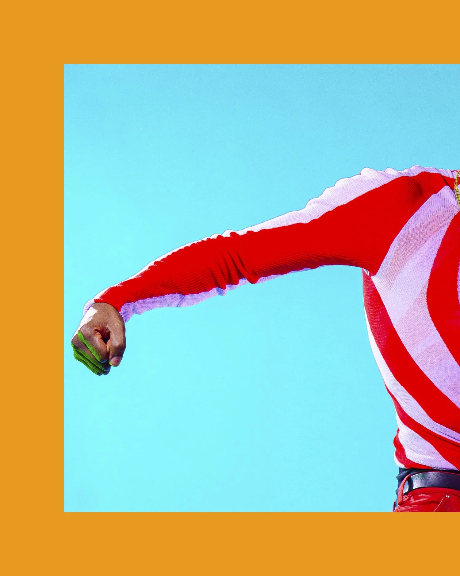 Close-up of a person wearing a red and white striped long-sleeve shirt against a turquoise background, with an orange border surrounding the image.